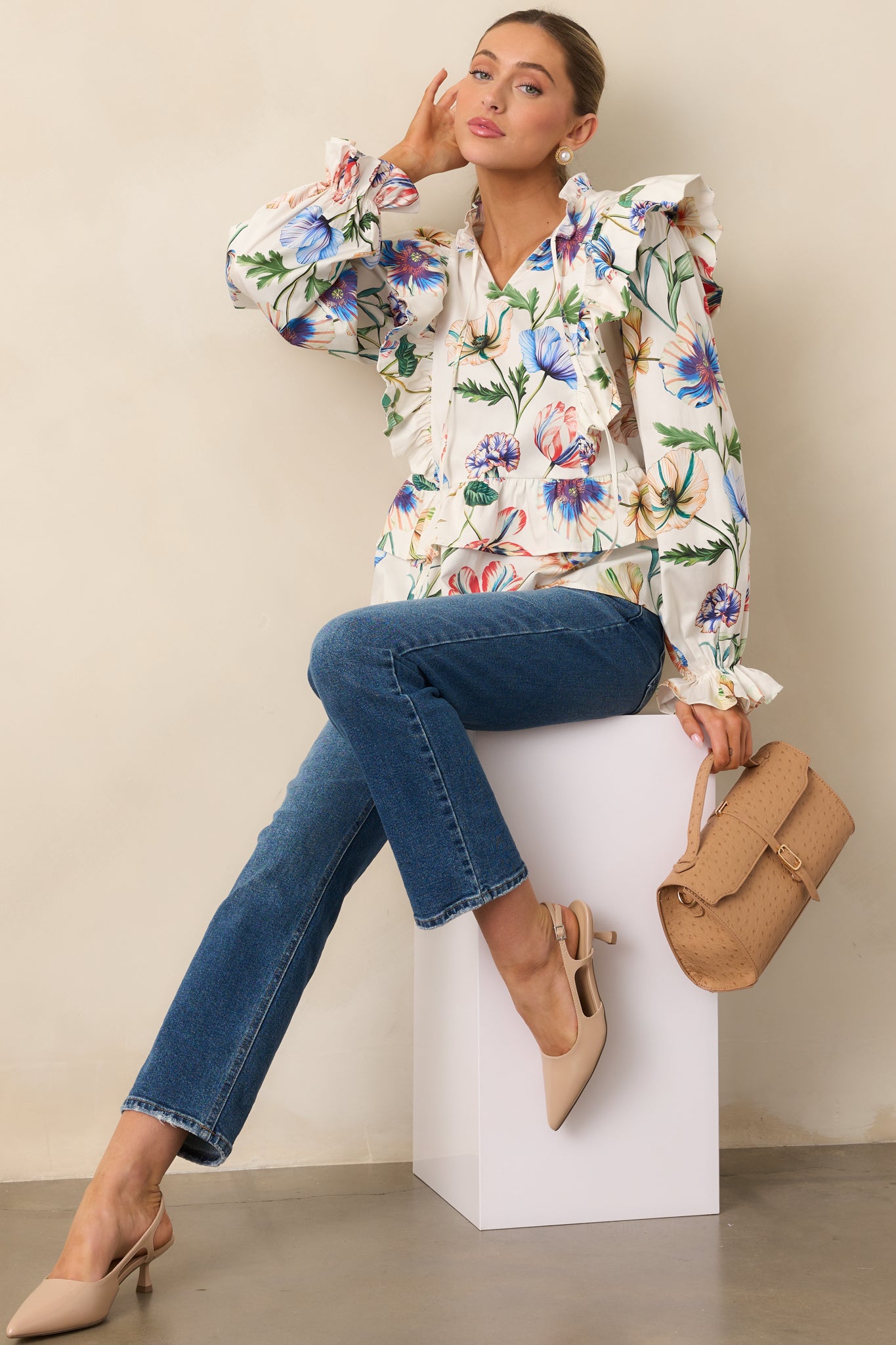 Ivory top with multicolor floral print, notch v-neckline, and optional self-tie tassels.