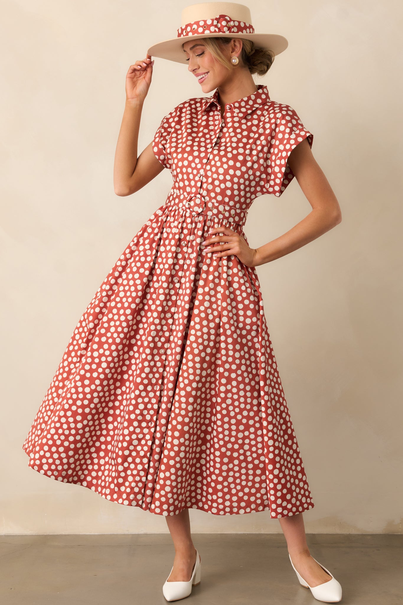Maxi dress with playful ivory polka dots, collared neckline, and a polished belted fit.