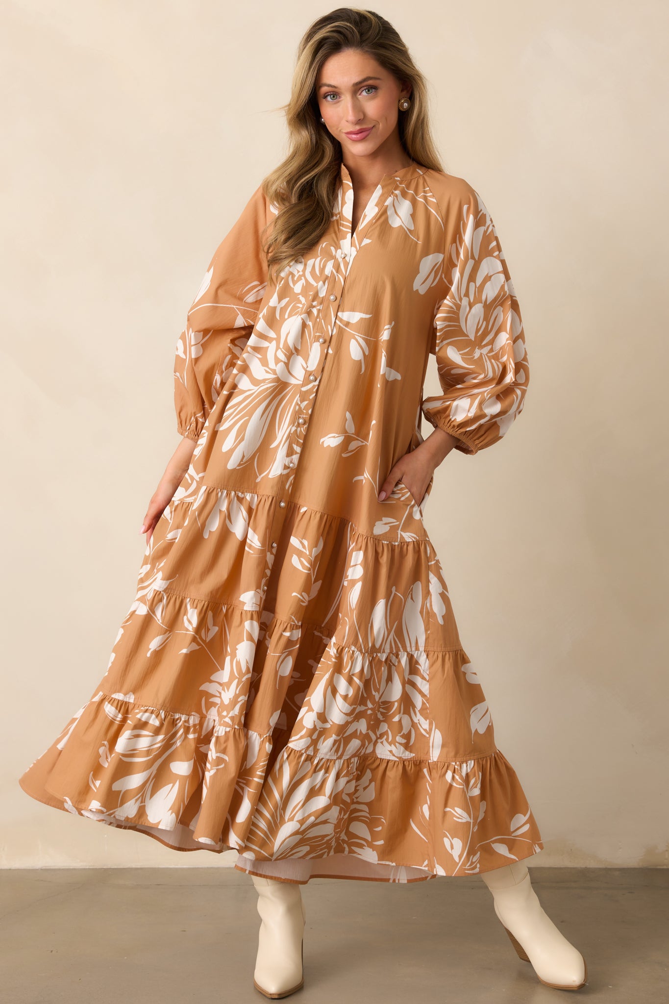 Flowing floral maxi dress featuring a notch v-neck, elastic cuffs, and functional side pockets for a relaxed, stylish look.