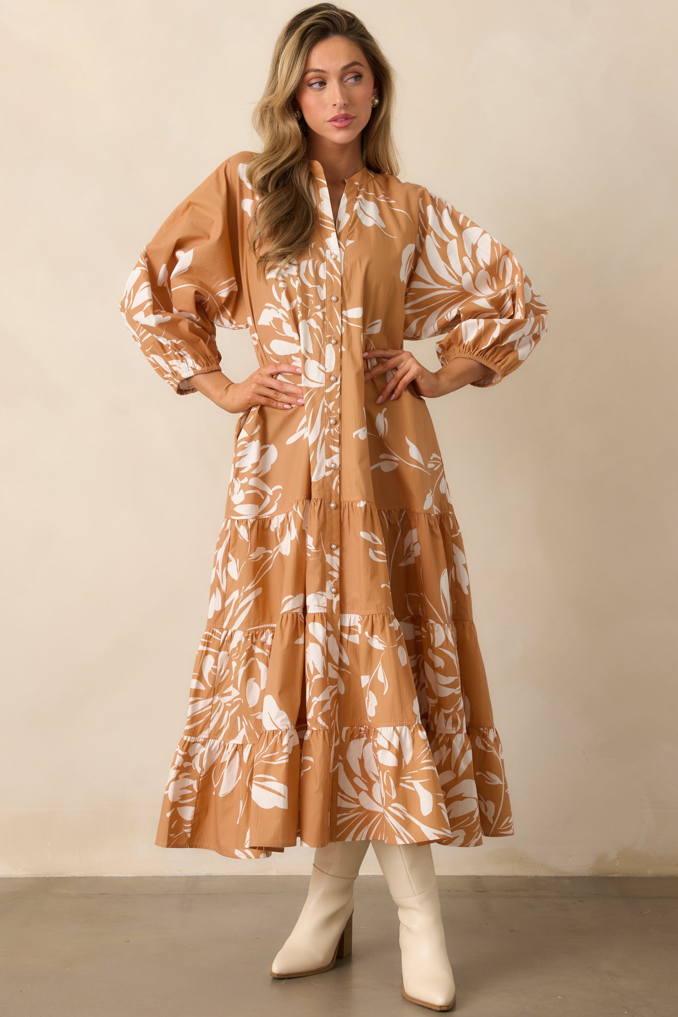 Long-sleeve floral maxi dress featuring puff sleeves with elastic cuffs and flowing tiered skirt.