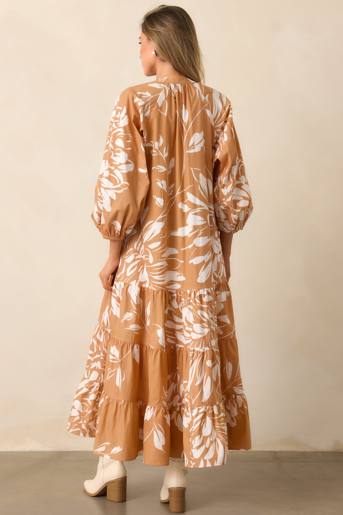 Rear view of the maxi dress showing long puff sleeves with elastic cuffs and tiered skirt silhouette.