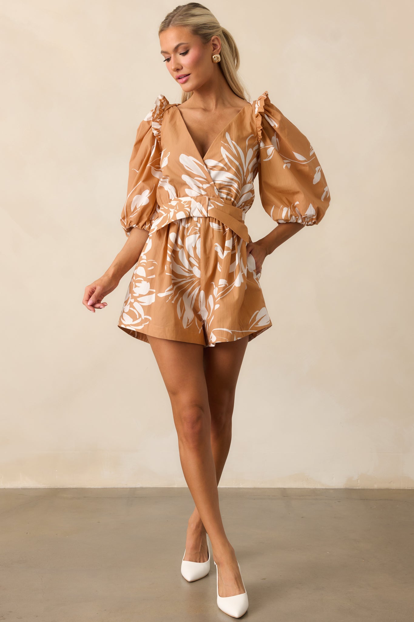 Prosperina floral romper featuring half-length sleeves, elastic cuffs, and decorative front bow.