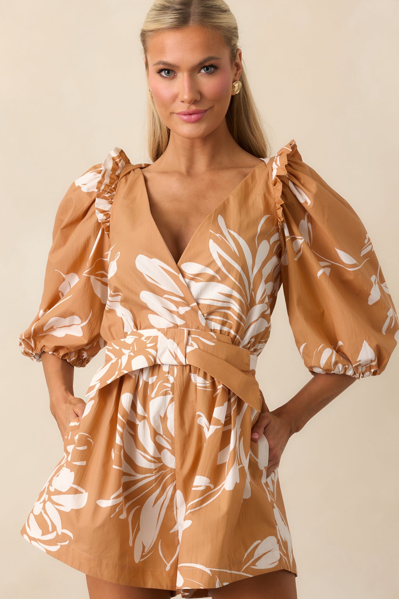Close view highlighting the deep v-neckline and snap button closure.