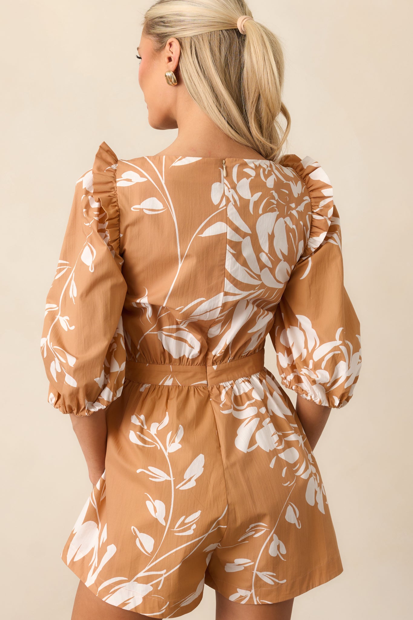 Rear view of the floral romper showing hidden zipper closure and relaxed silhouette.