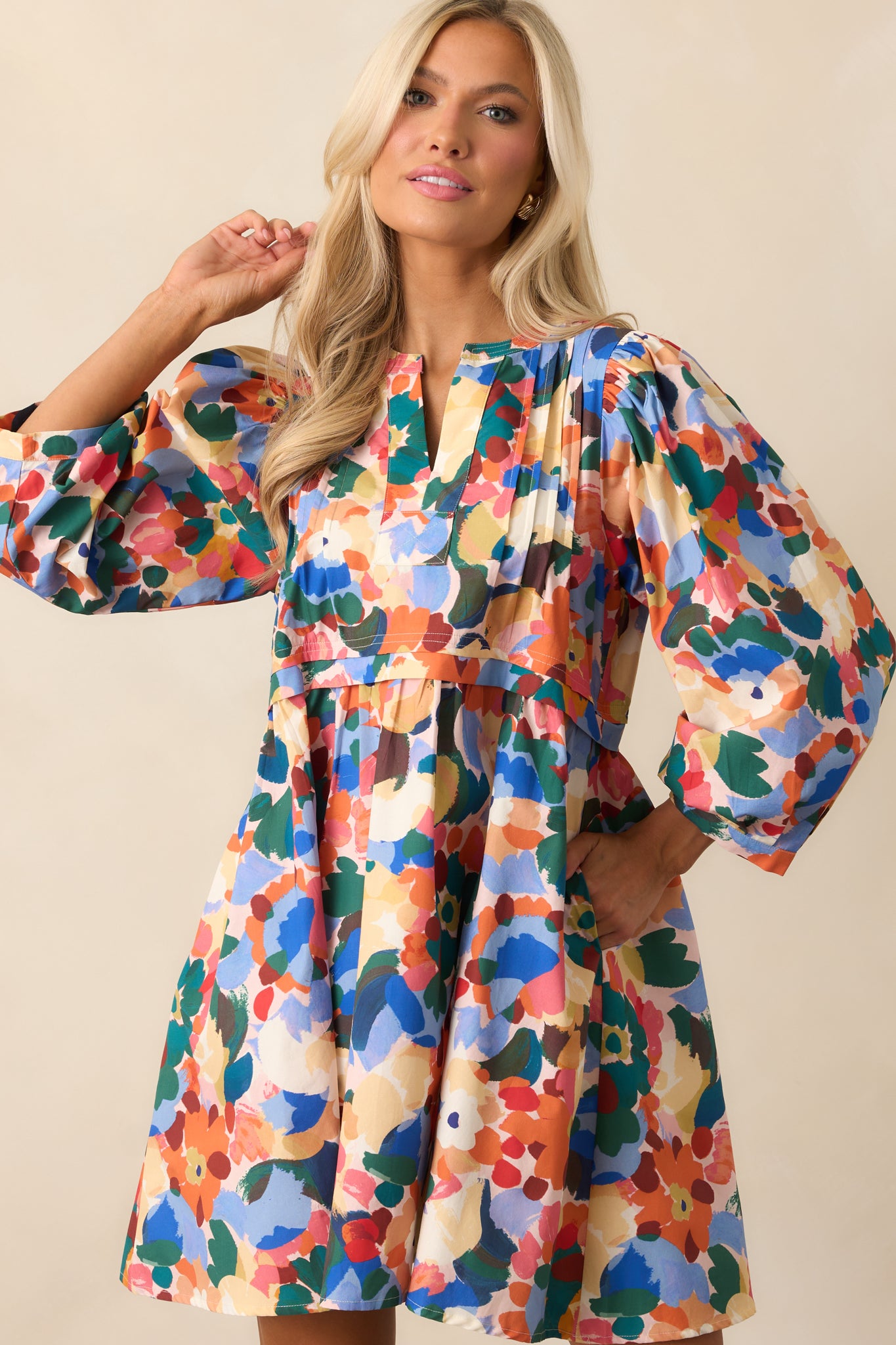 Detailed front view showing the floral print and side seam pockets.