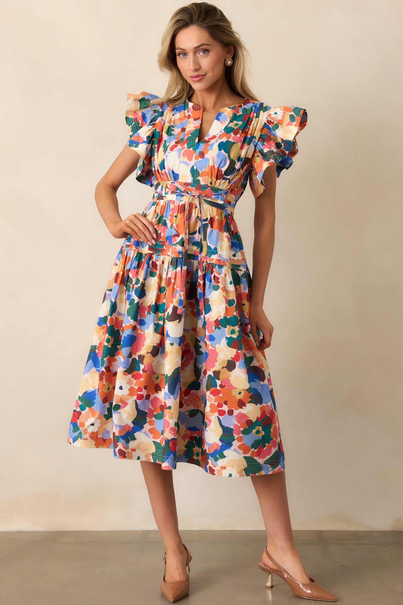 Tiered orange floral midi dress with split neckline and relaxed fit, styled with a belt option.