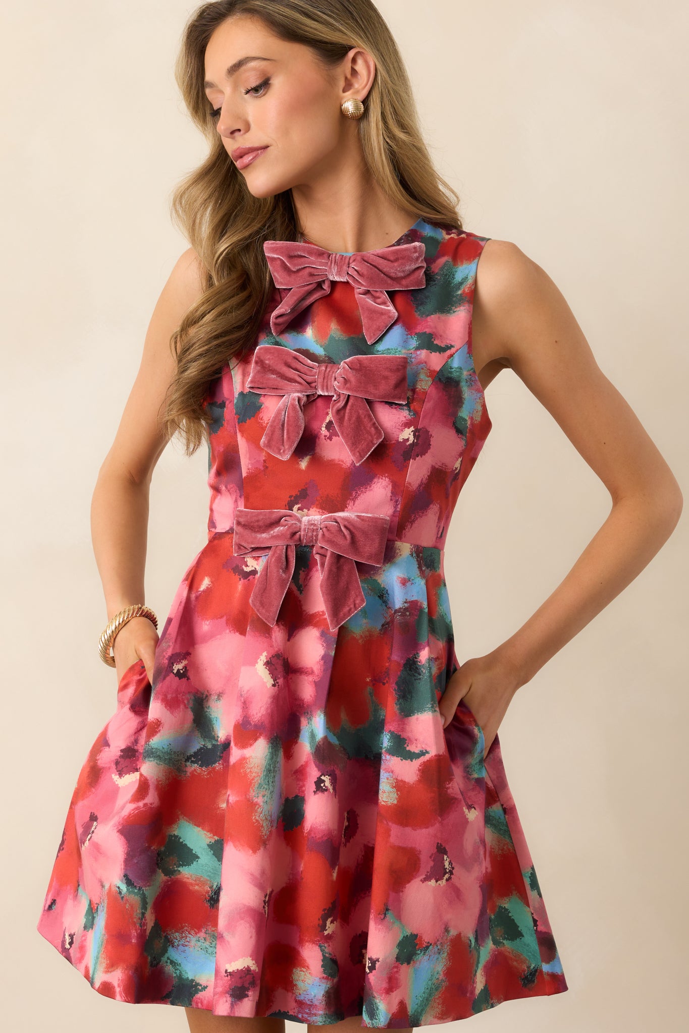 Focus on the fitted bodice and princess seam detailing of the pink floral mini dress.