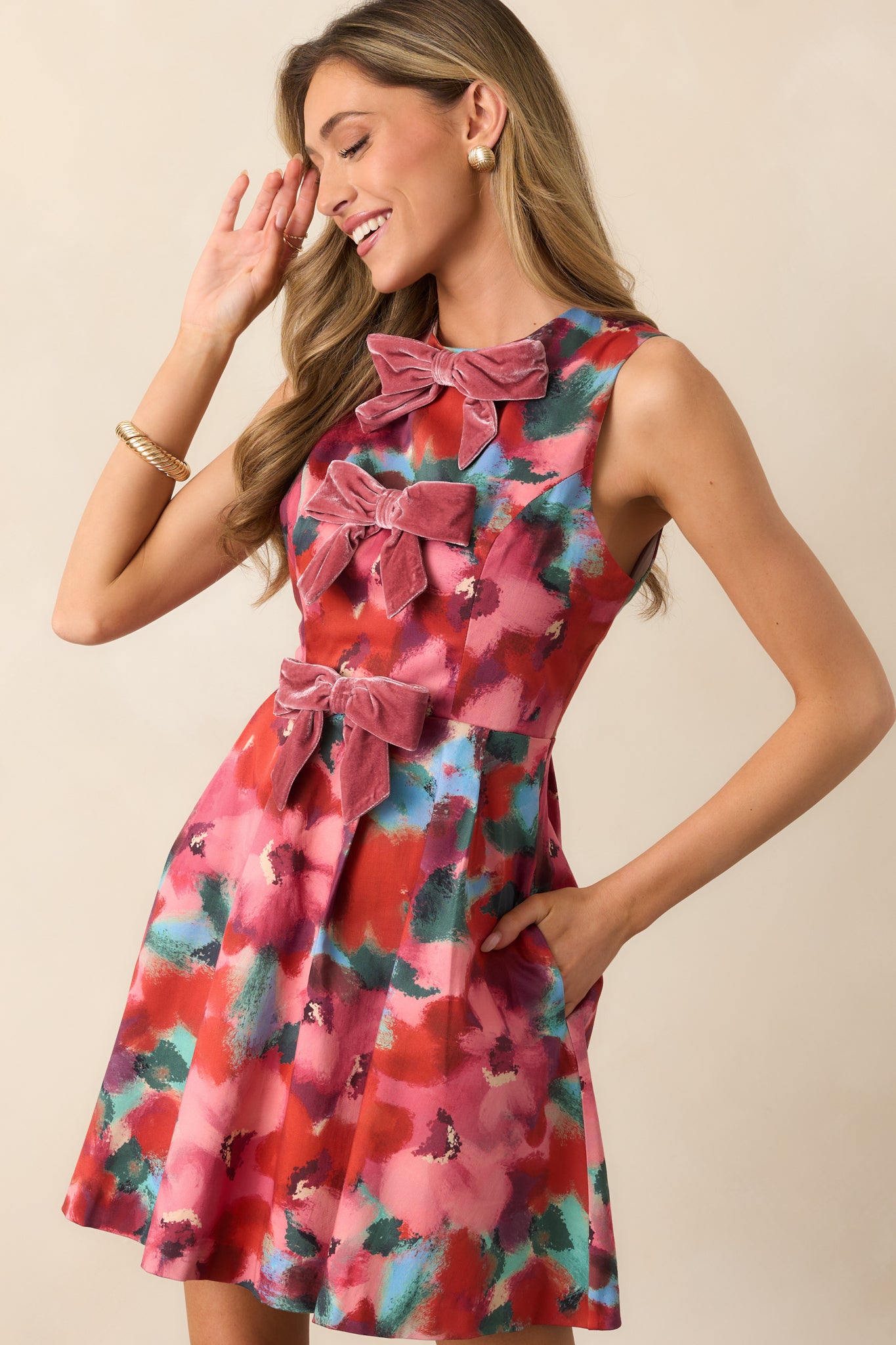 Zoomed-in look at the flared pleated skirt showing the lively multicolor floral print.