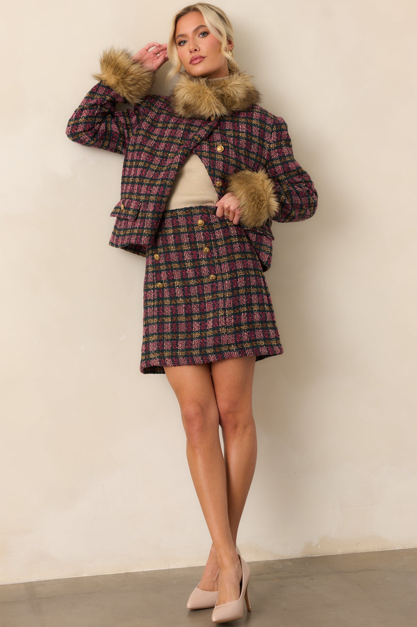 Pink and green plaid tweed jacket styled to showcase the boxy silhouette, faux fur collar, and cuff details.