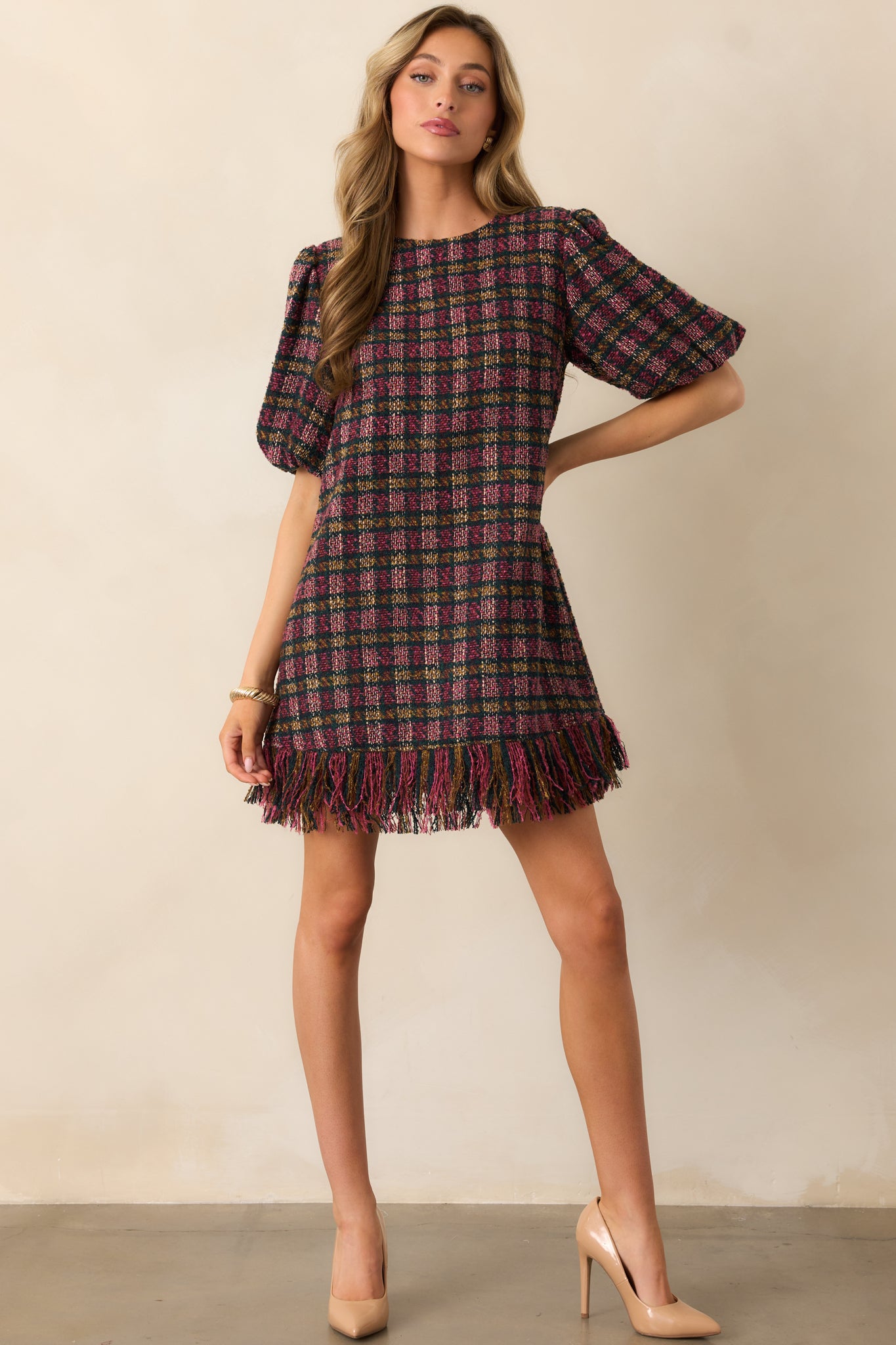 Pink and green plaid tweed mini dress with short puff sleeves and a fringed hem.