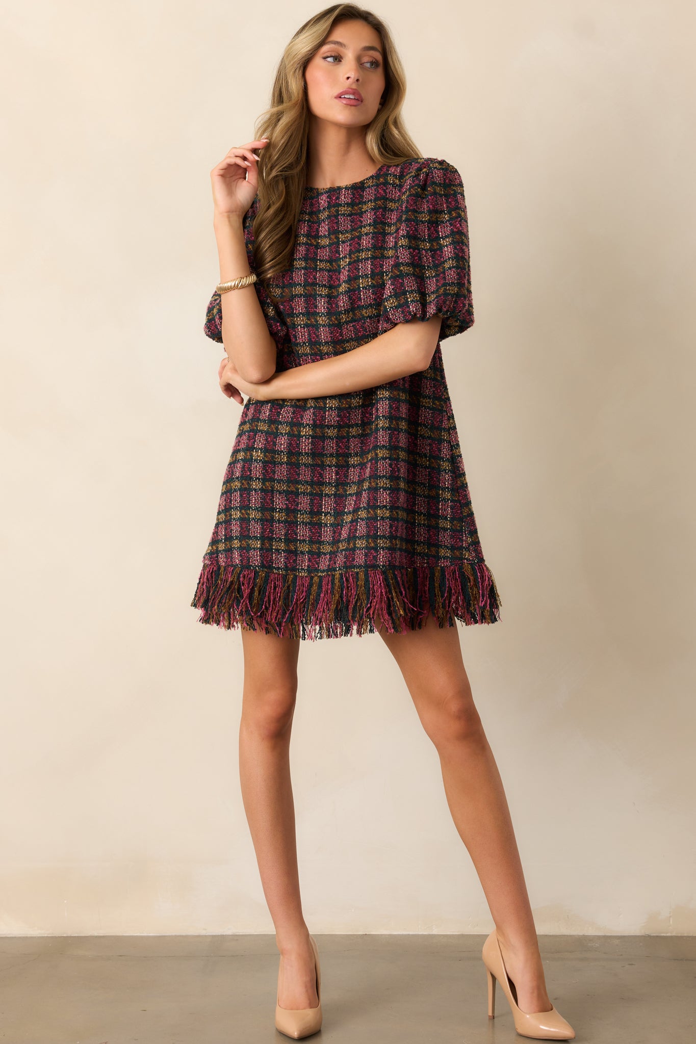 Pink and green plaid tweed mini dress showcasing its cheerful colors and timeless shift silhouette.