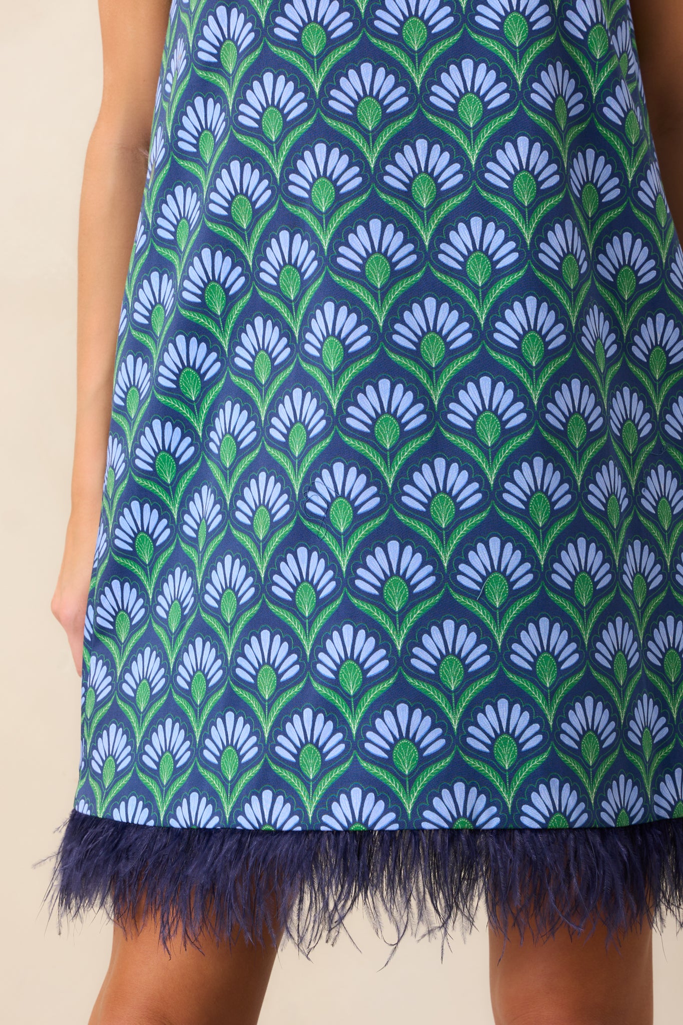 Close-up of the feather trim and geometric print fabric showing the vivid colors and texture.