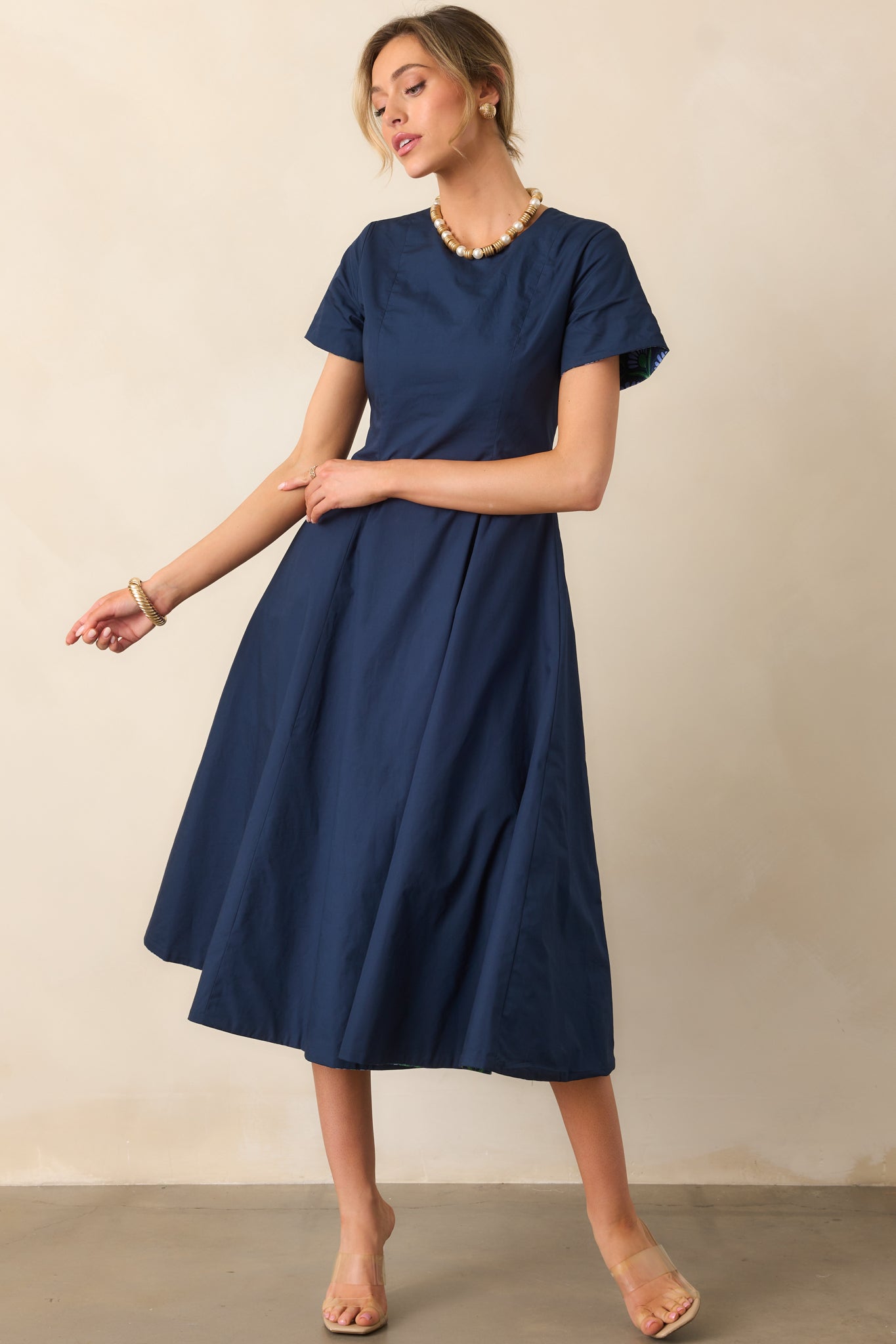 Fitted midi dress with solid midnight blue side and contrasting multicolor geometric print on the other.