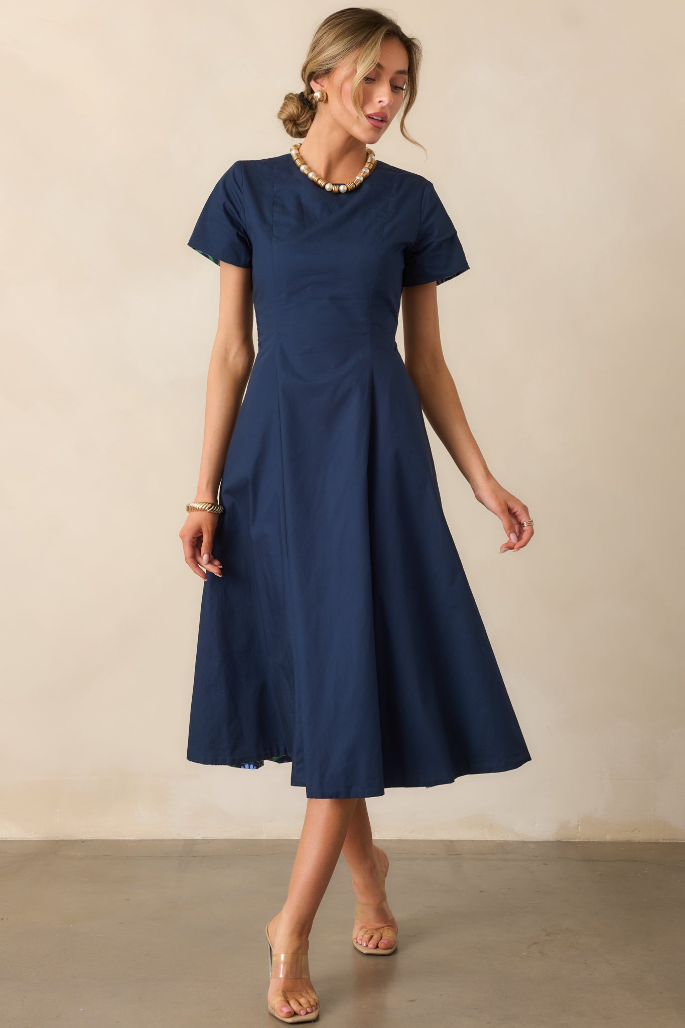 Solid blue side emphasizing the crew neckline and structured silhouette.