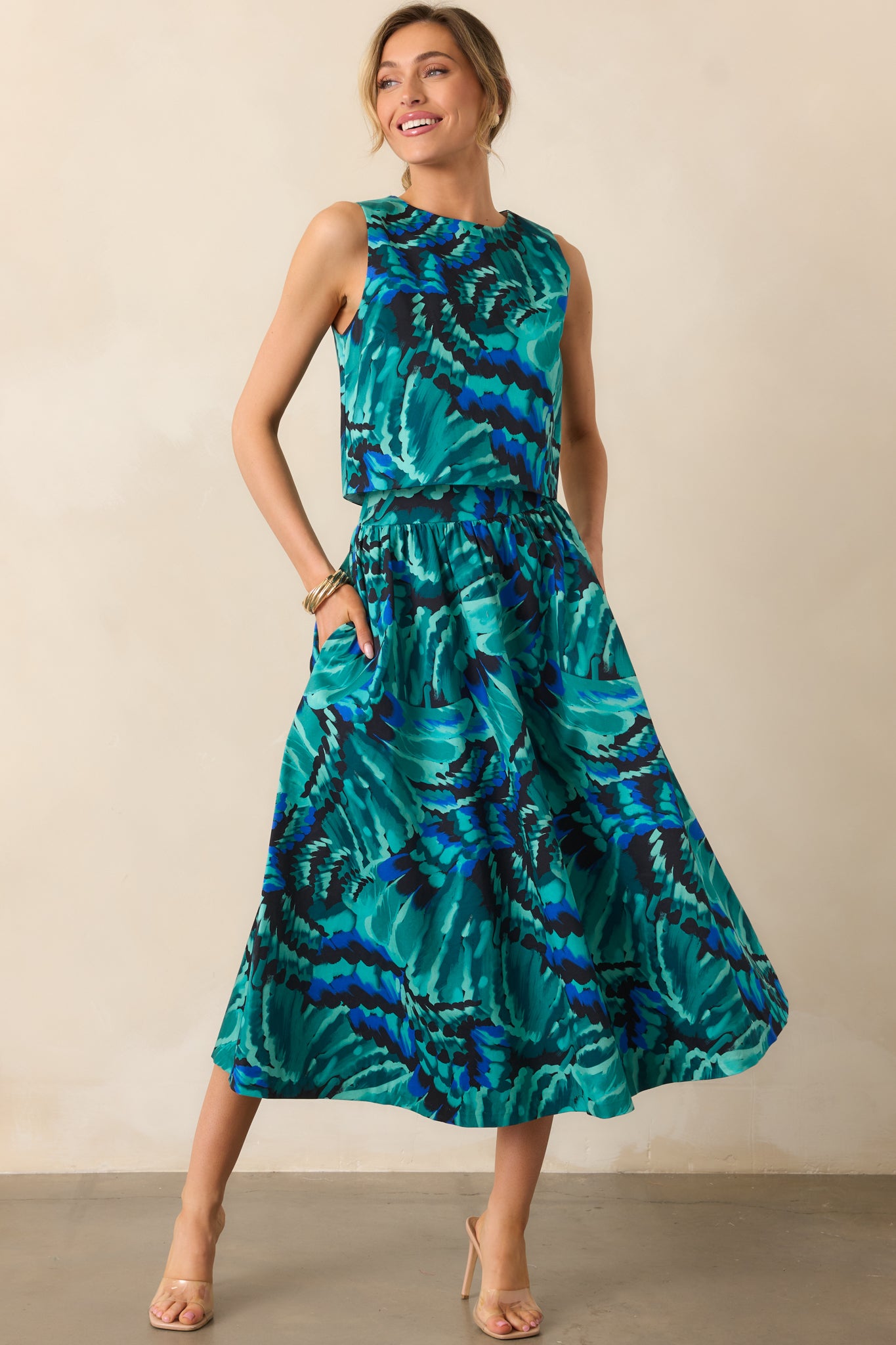 Blue multicolor abstract print midi skirt with a high-rise waist and flowing silhouette.