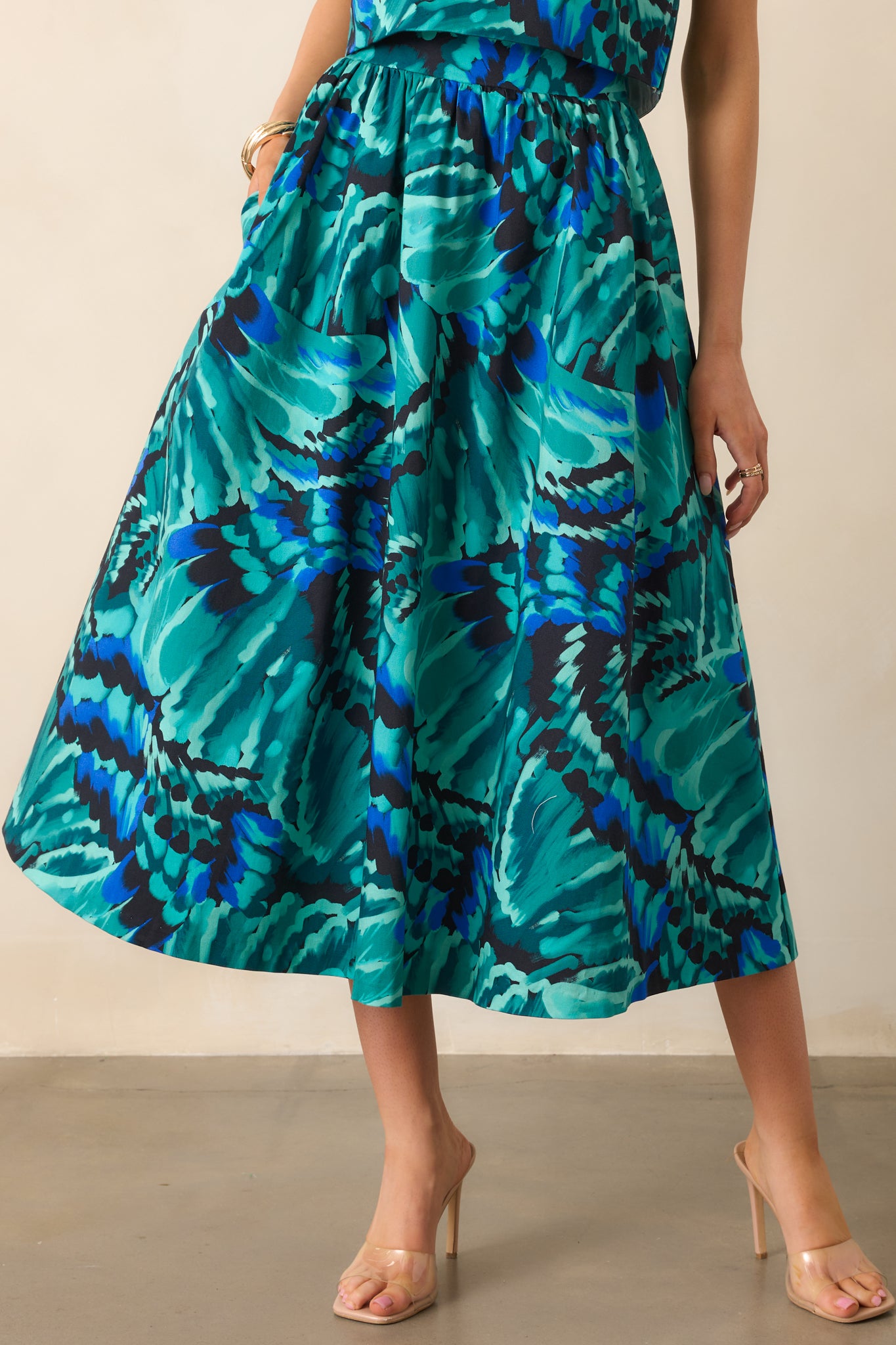 Close view of the abstract print pattern and high-rise waistband of the skirt.