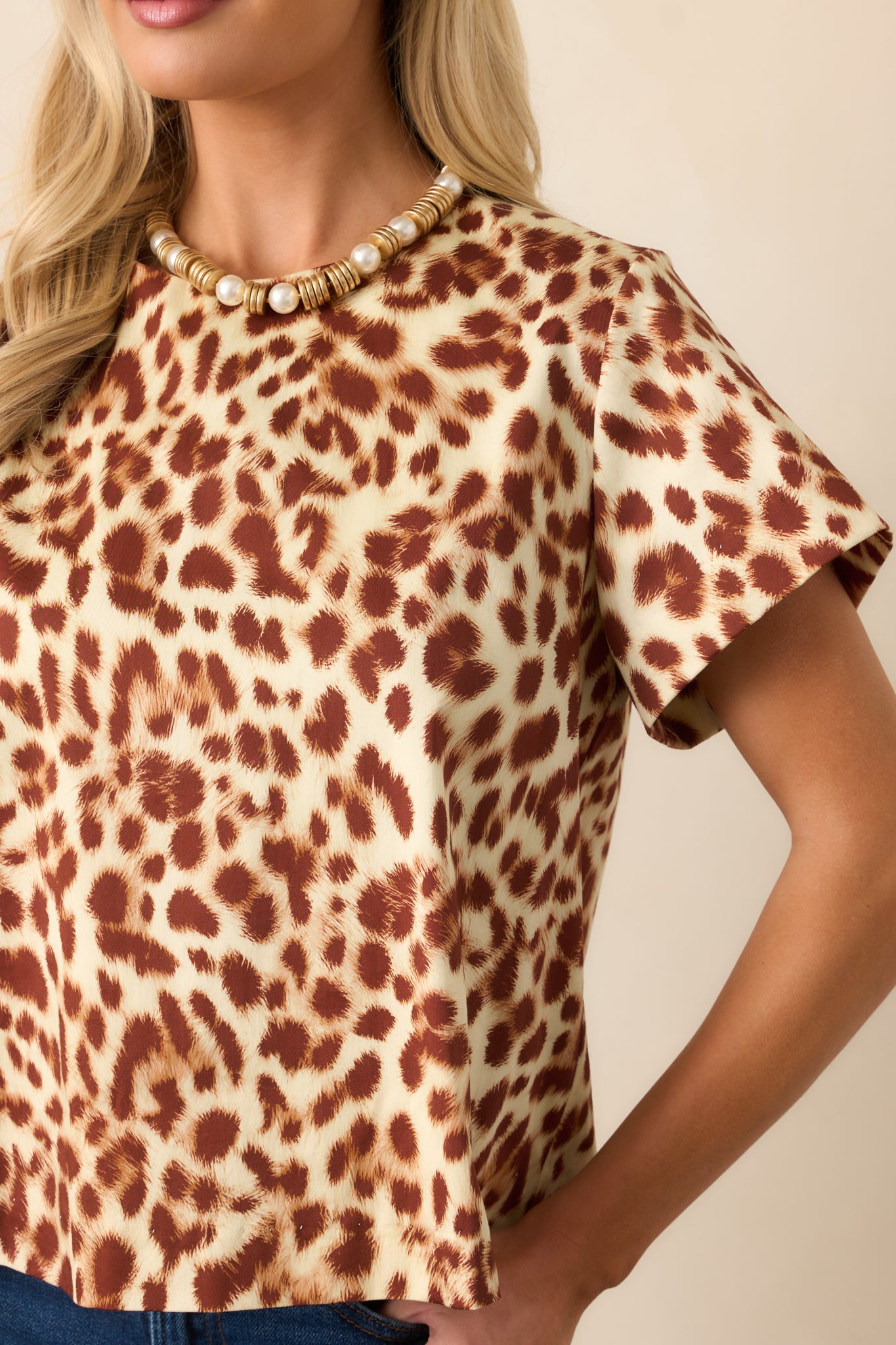 Close-up of the lightweight cotton fabric showing the ivory and brown leopard print.