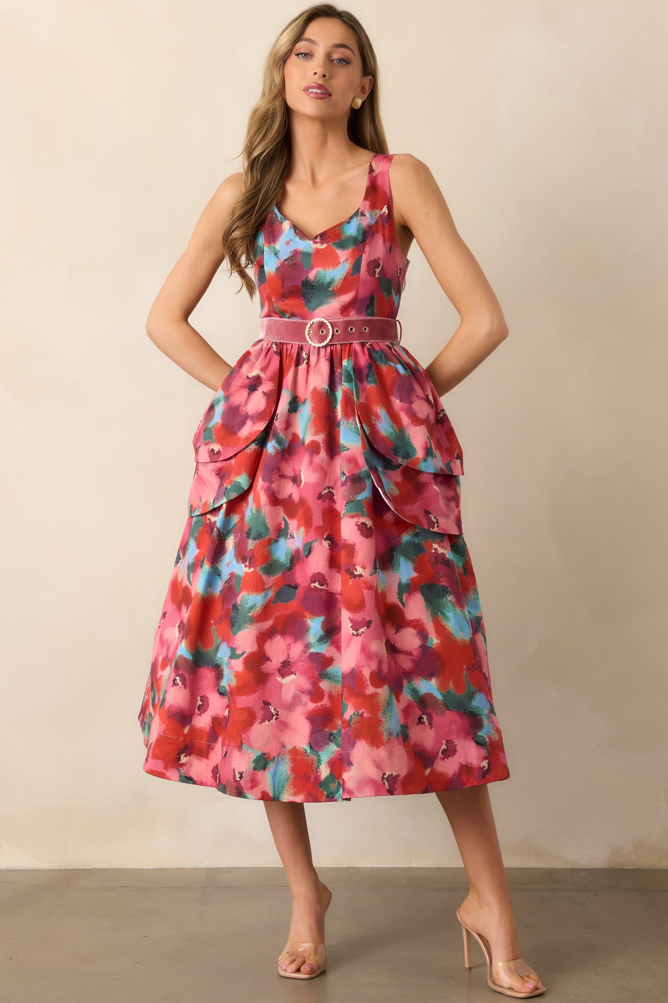 Pink watercolor floral midi dress with a scoop neckline, sleeveless design, and velvet belt with gold buckle.