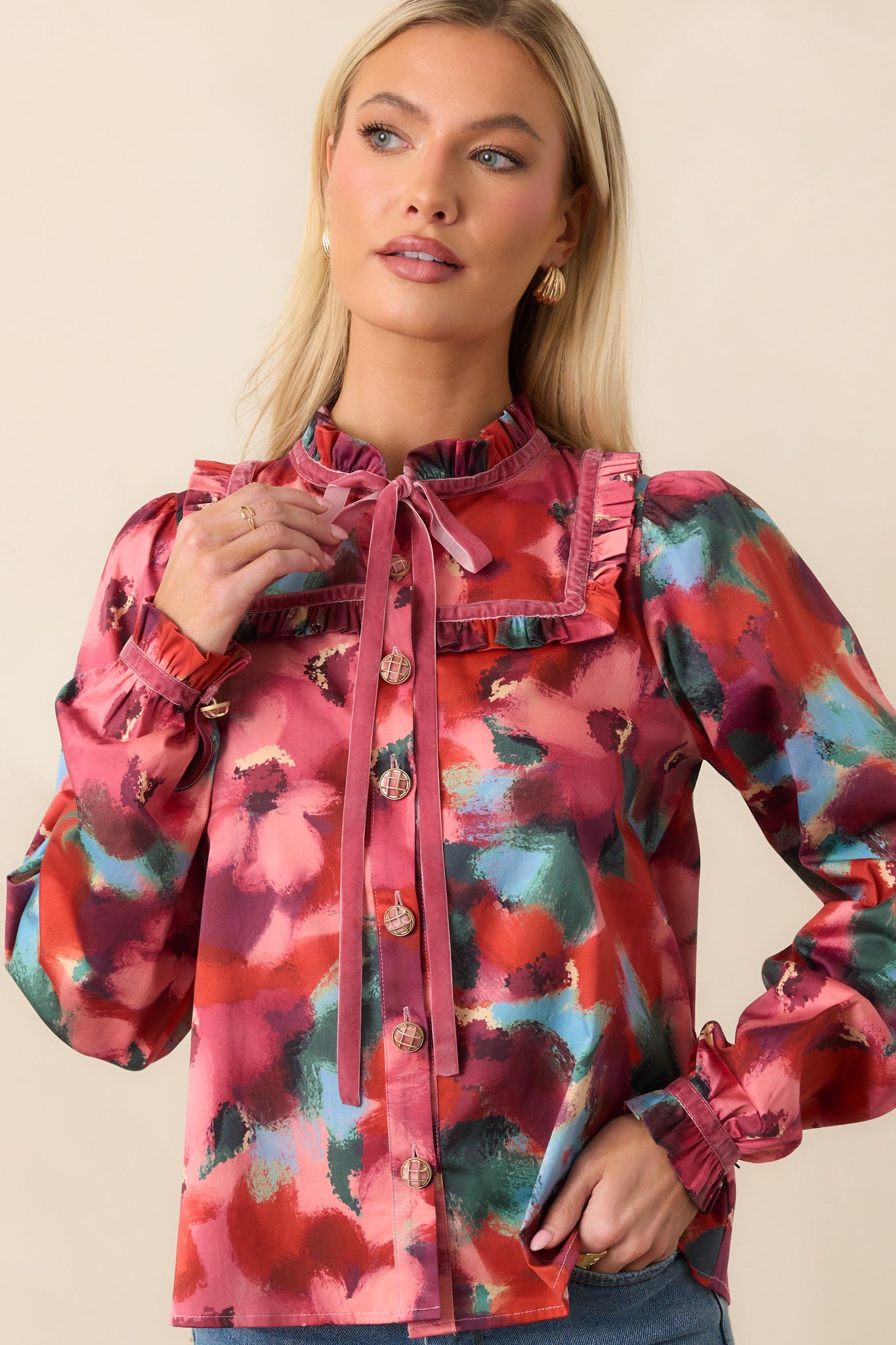 Close-in shot of the sailor-style ruffle collar and multicolor floral pattern around the neckline and shoulders.