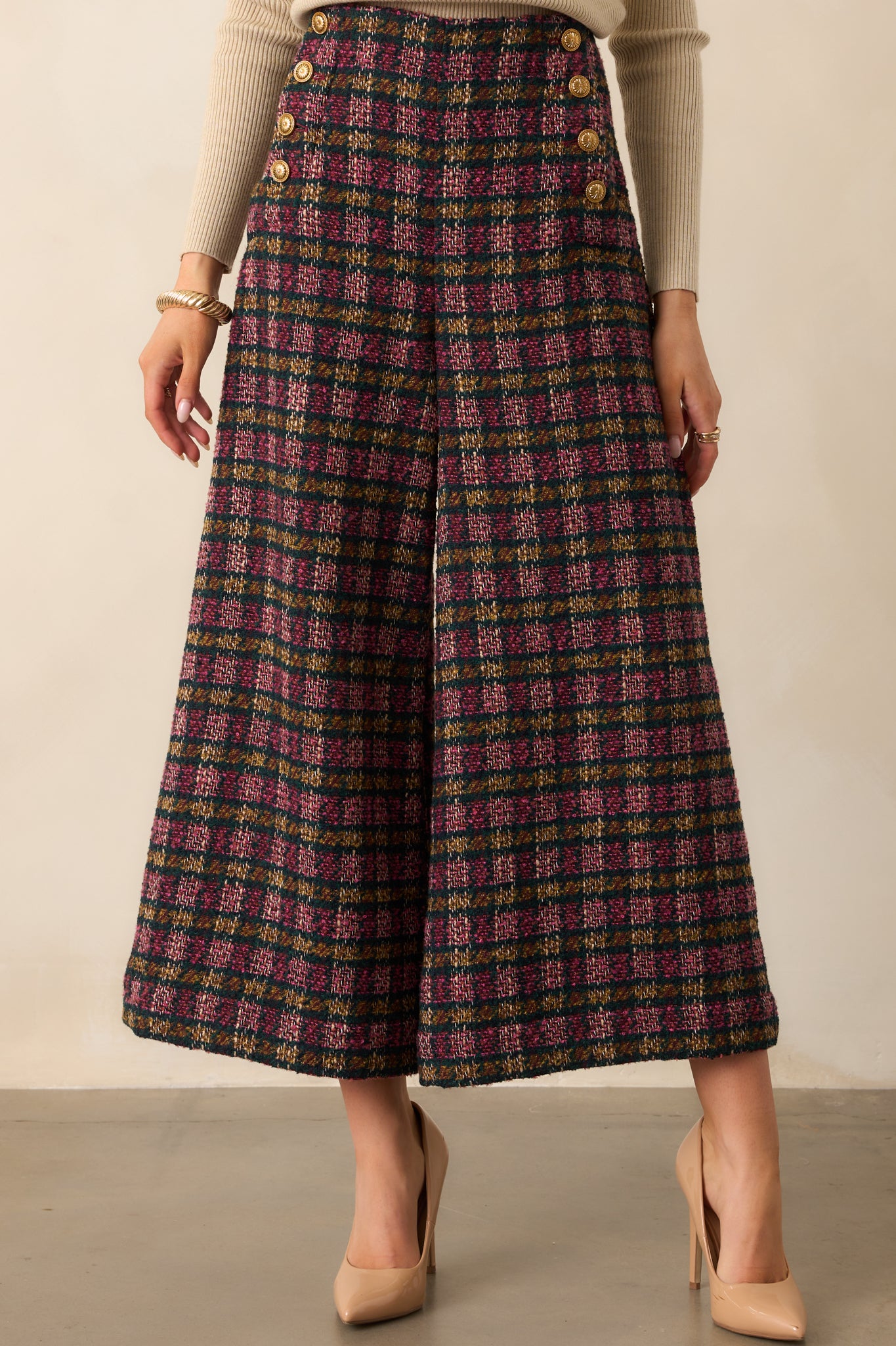 Focus on the front pockets and plaid tweed fabric texture of the wide-leg cropped pants.
