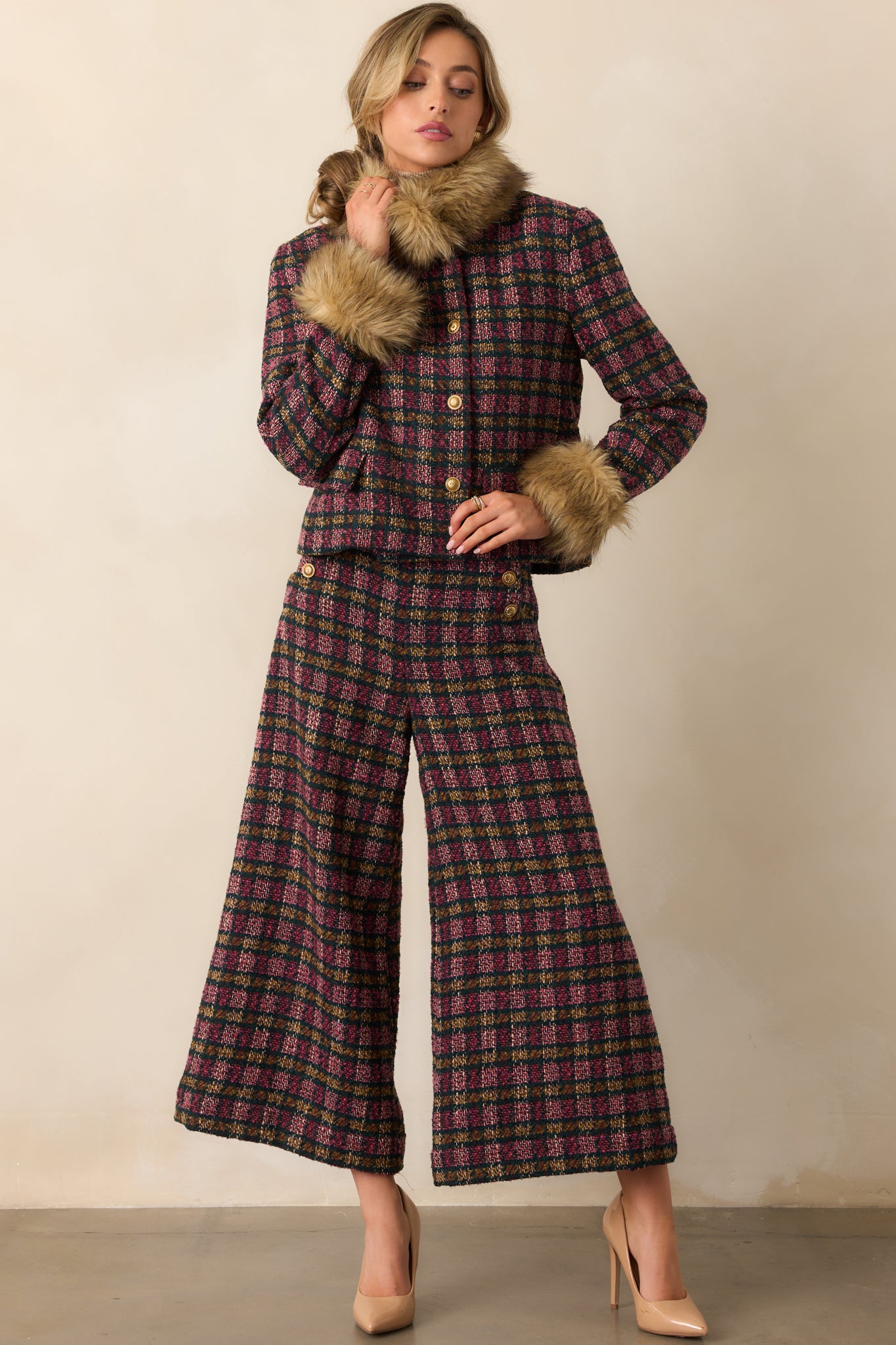 Wide-leg cropped plaid pants showing the vibrant tweed fabric and polished button detailing.