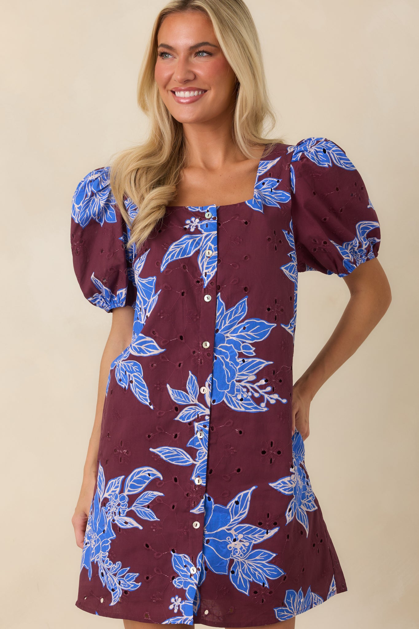 Mini dress detail featuring puff sleeve texture, floral print, and lightweight lined construction.