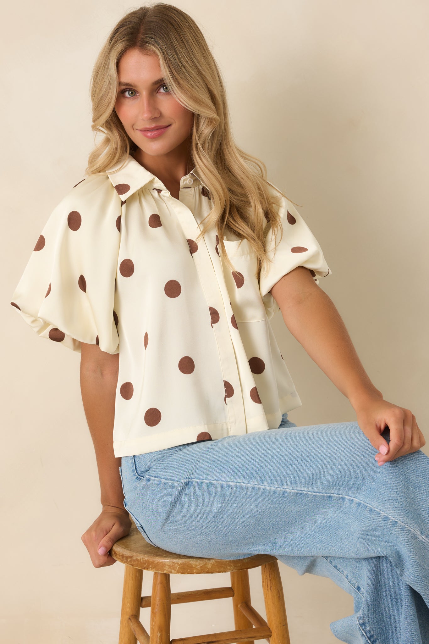 Voluminous puff sleeve detail creates a statement look with gathered shoulder detailing and smooth woven fabric.