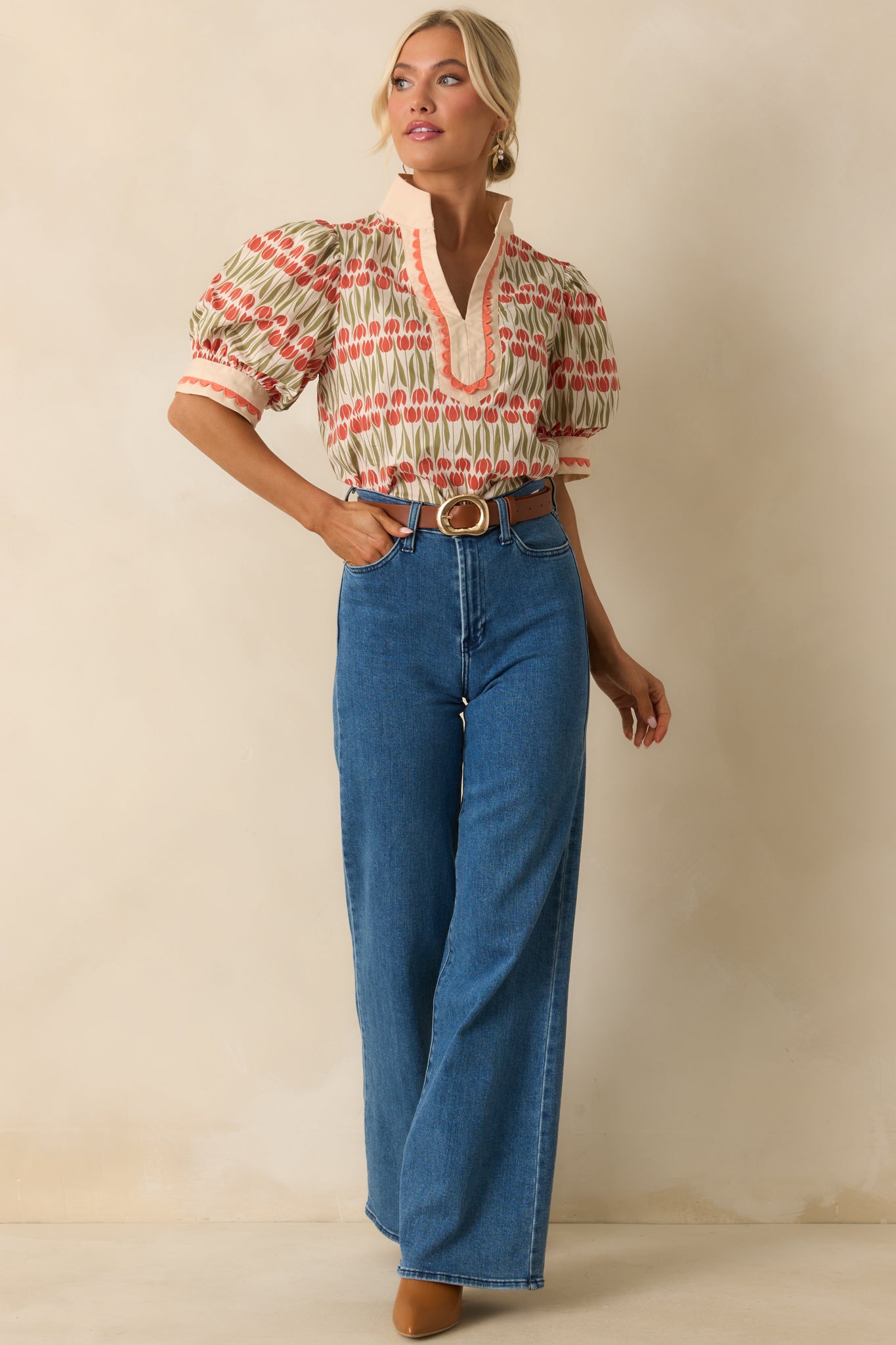 Puff-sleeve ivory blouse decorated with tulip blooms, paired with delicate embroidery and a relaxed silhouette.