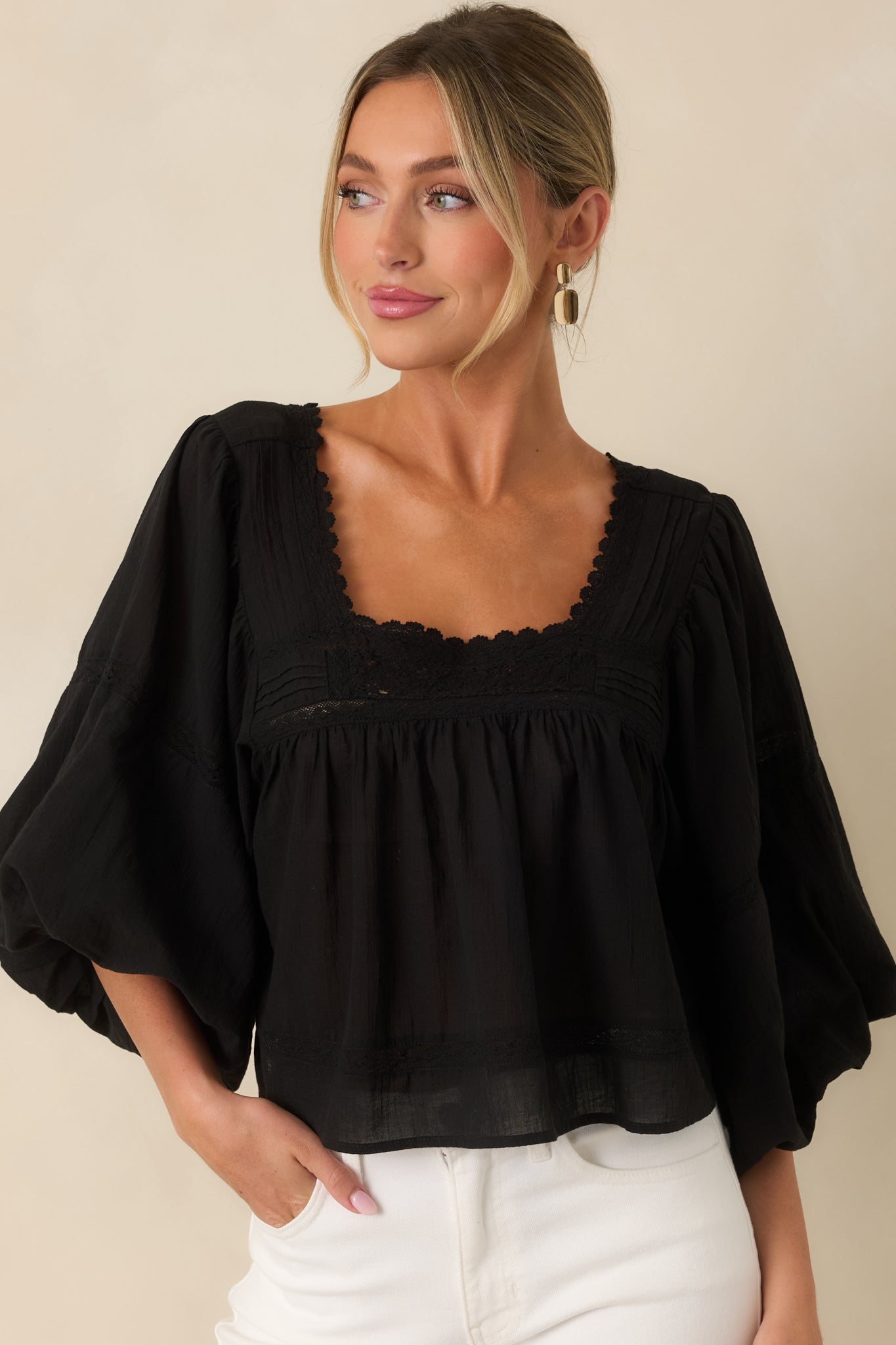 Detailed front view featuring the voluminous puff sleeves and relaxed drape of the lightweight blouse.
