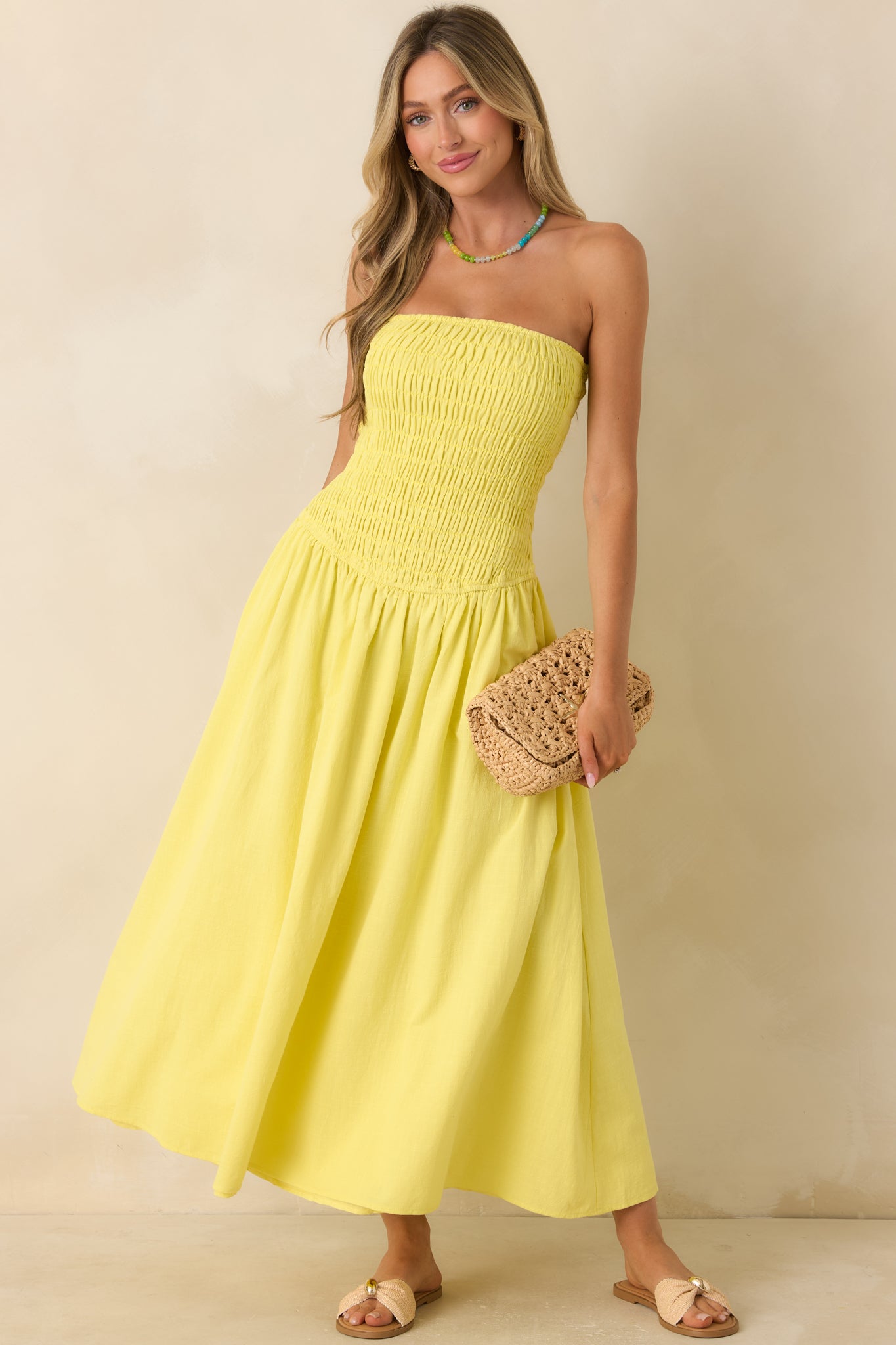 Strapless pull-on maxi dress in yellow with a fitted smocked top and a softly draped full-length skirt.