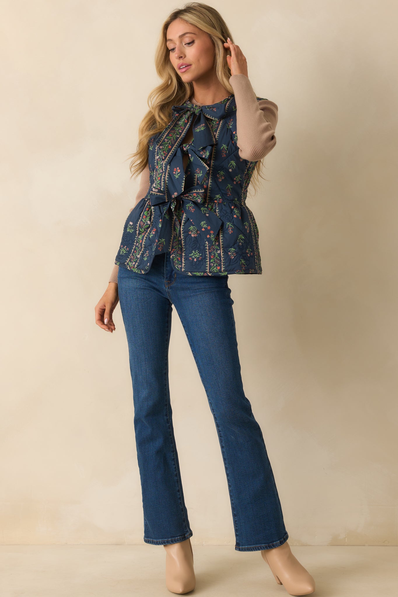 Quilted floral vest highlighting subtle embroidered details and structured fit.