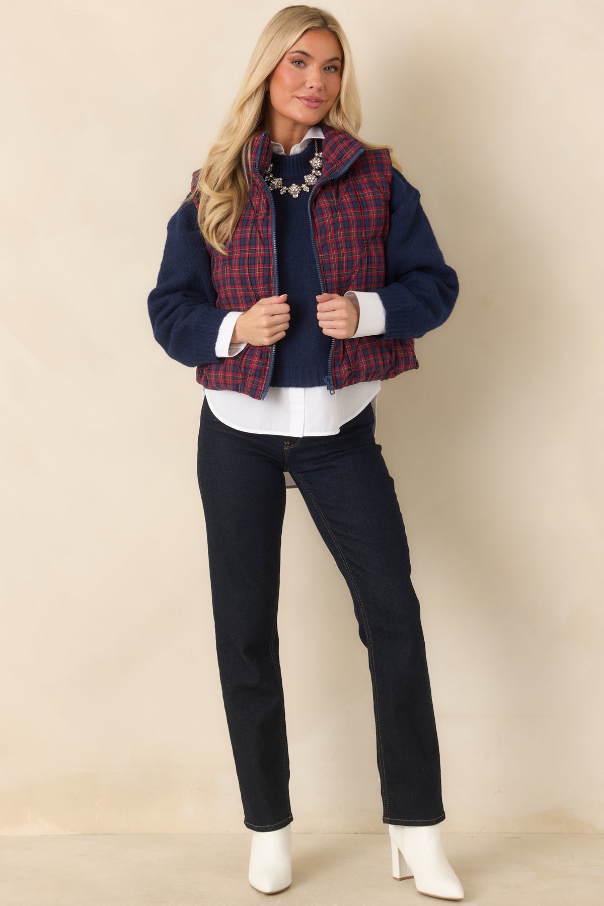 Quilted plaid vest with a structured stand collar and contrasting navy zipper down the front.