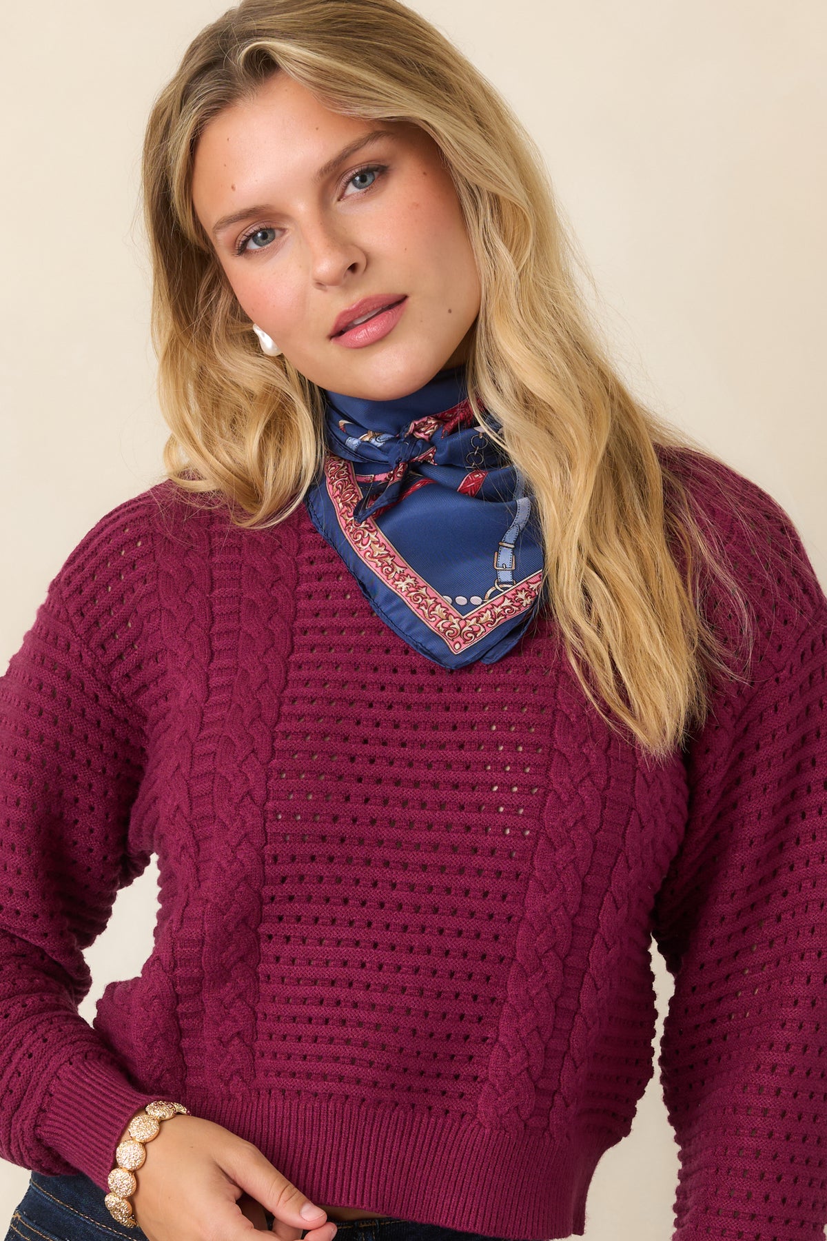 Deep raisin knit top featuring long sleeves and ribbed cuffs for a polished finish.