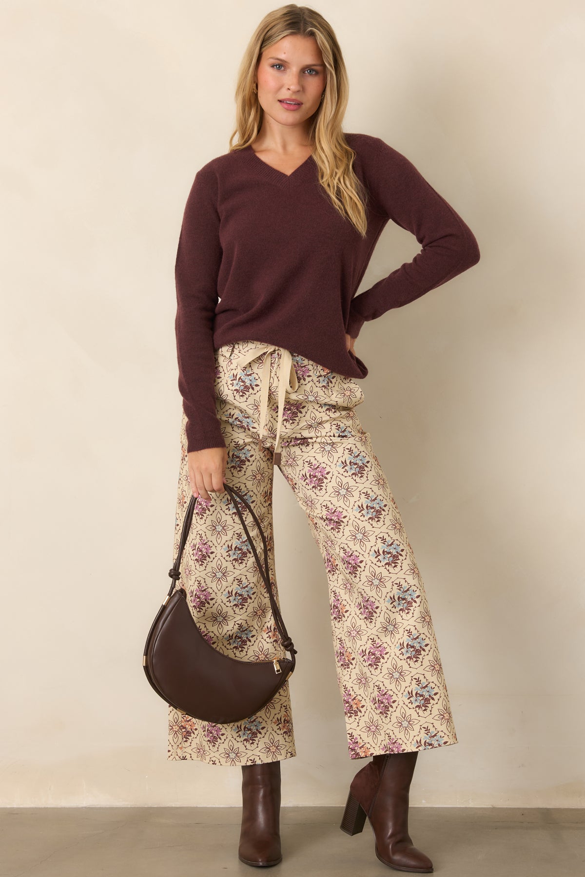 Raisin knit top showcasing ribbed neckline, cuffs, and hem with a softly structured shape.