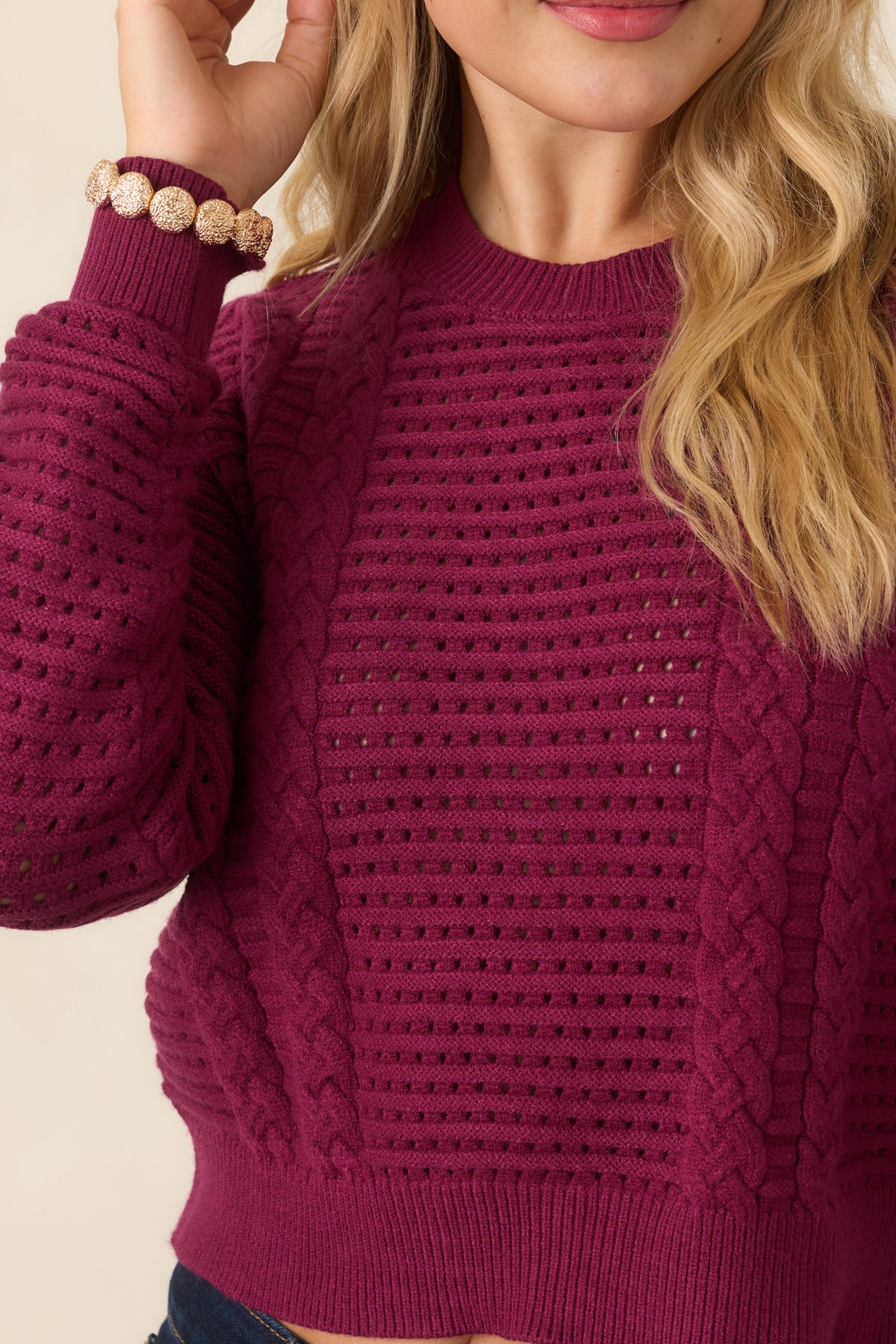 Close-up detail of the raisin knit top showing the ribbed trim.