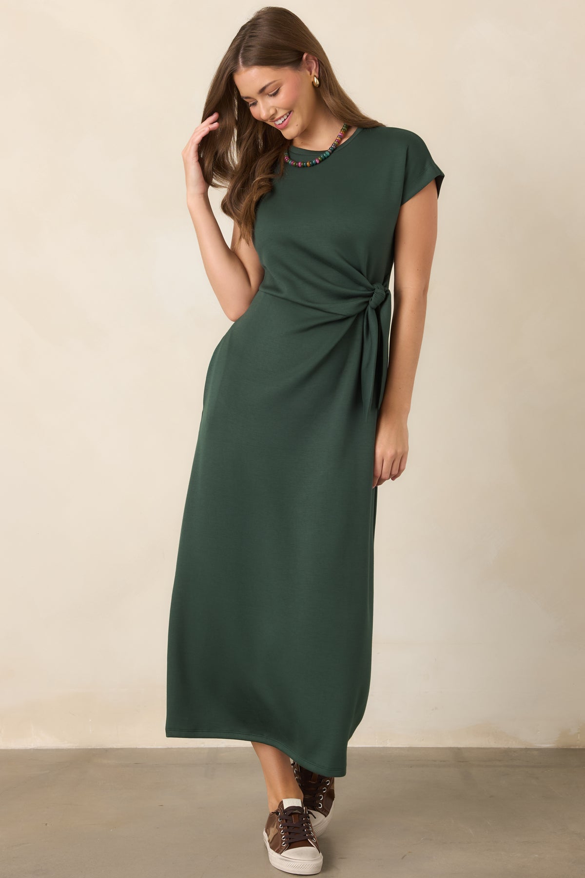 Rayon-blend midi dress highlighting its flexible construction, polished smooth texture, flattering drape, and softly defined knotted waist.