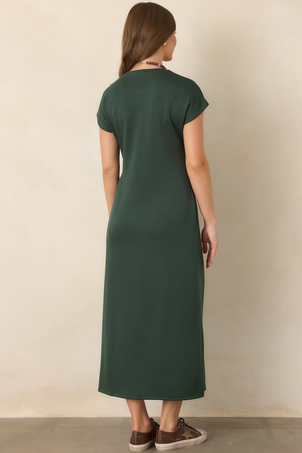 Rear view of the rayon-blend midi dress showcasing its smooth stretch fabric, fluid drape, and softly shaped silhouette.