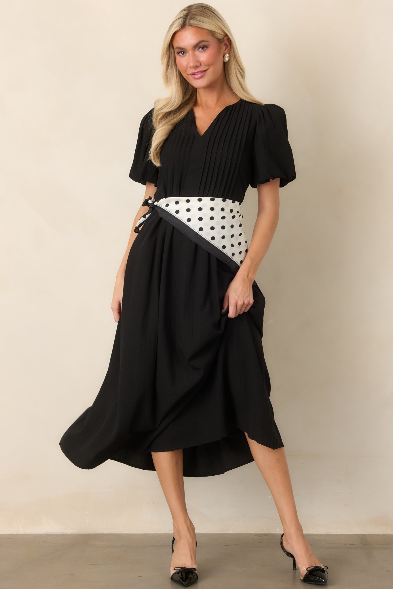 Lightweight rayon-nylon midi dress featuring a V-neckline, softly gathered puff sleeves, front pintuck detailing, and a flowing skirt.