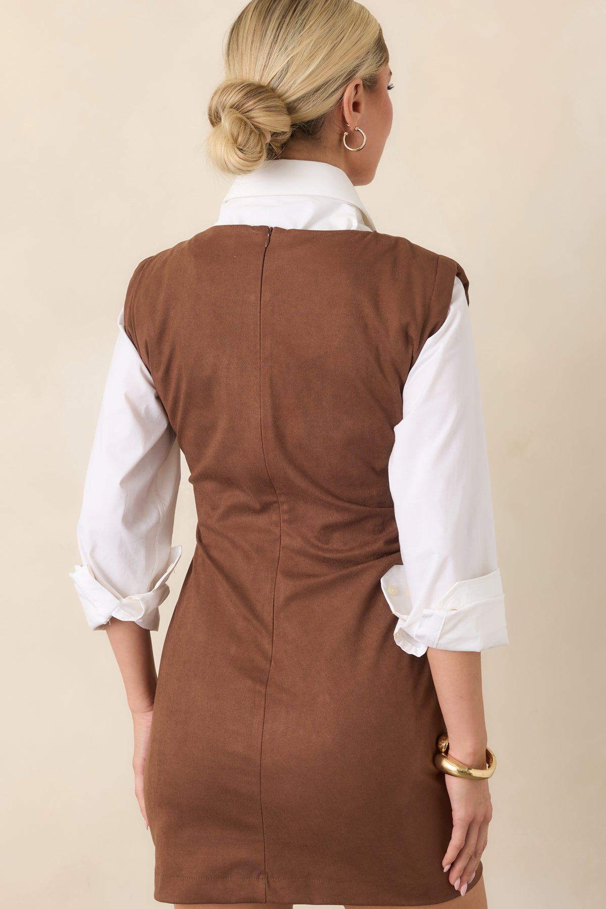 Rear of the fitted brown mini dress showing the concealed zipper and softly ruched waist.
