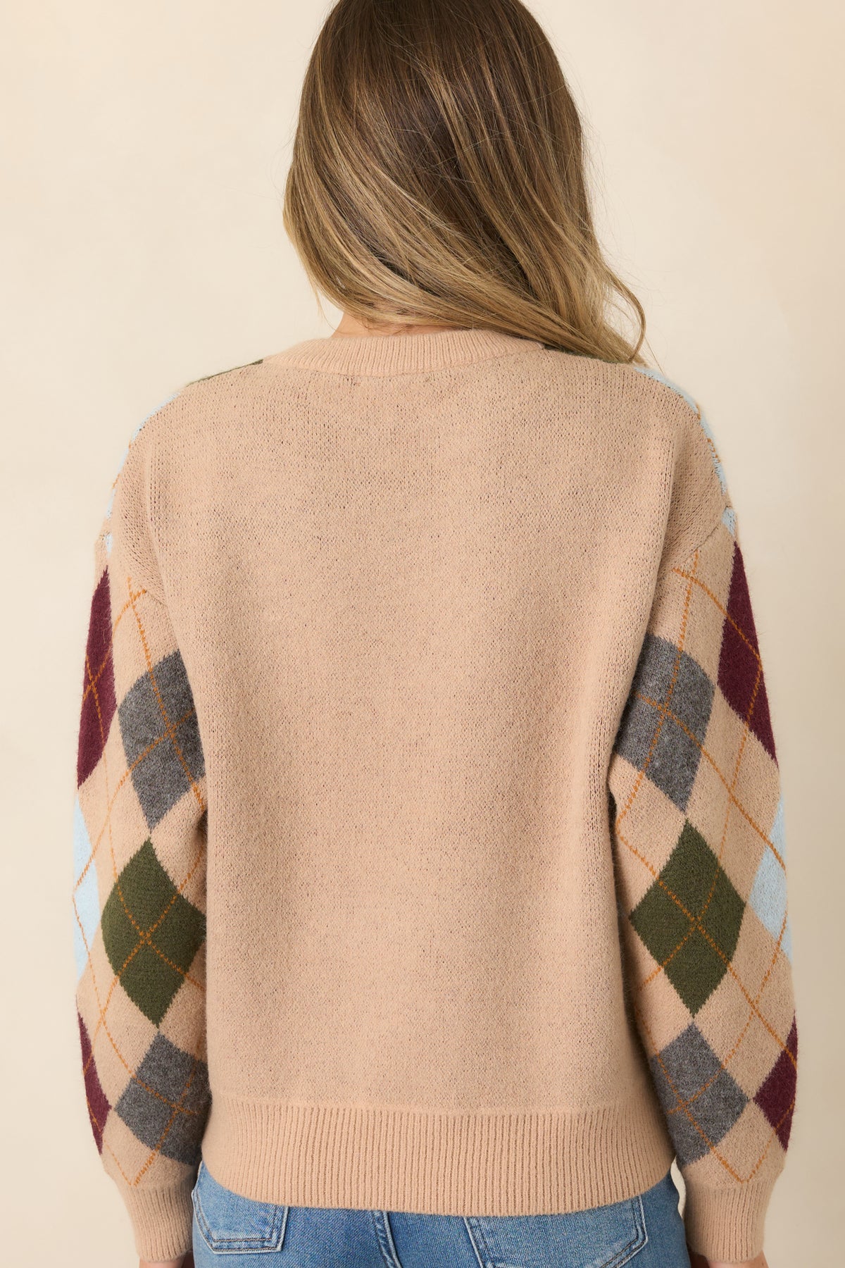 The rear of the camel sweater continues the multicolor diamond pattern with a relaxed fit and ribbed hem.