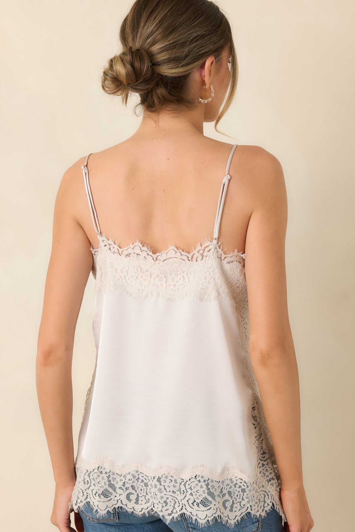 Rear of the champagne satin camisole featuring slim adjustable straps, a smooth satin back, and lace-trimmed edges.