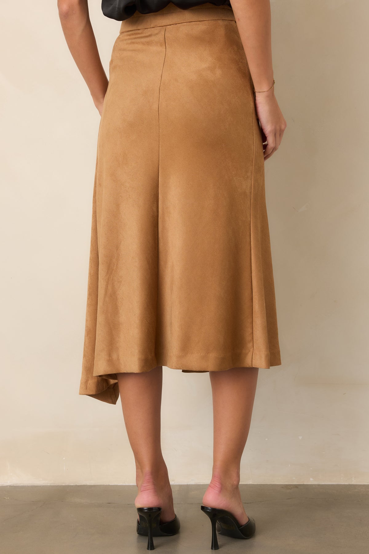 Rear of the faux suede skirt features a clean, streamlined design beneath the high-rise waist