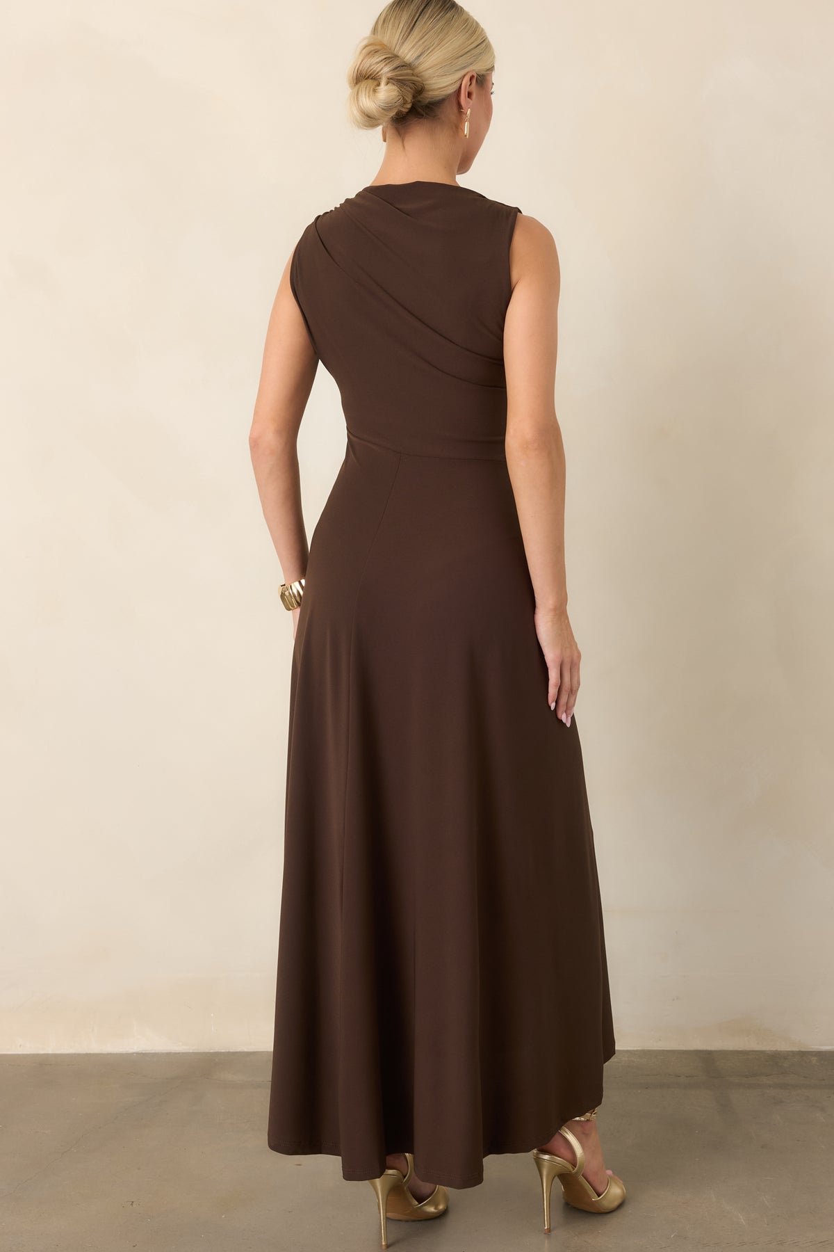 Rear of the fitted maxi dress showcasing the smooth stretch fabric, gently flared skirt, and streamlined silhouette.