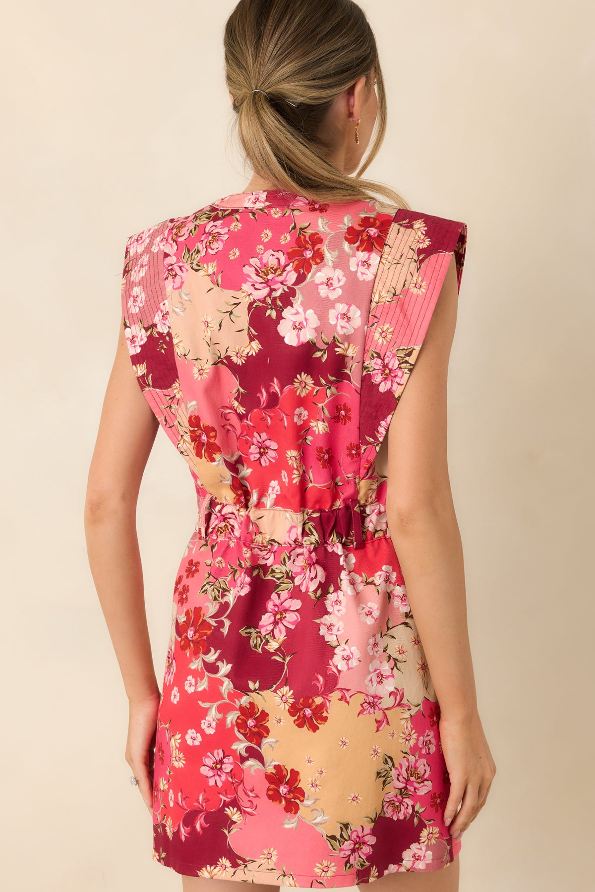 Rear of the floral cotton denim mini dress showing the elasticized back waistband and sleeveless cut.