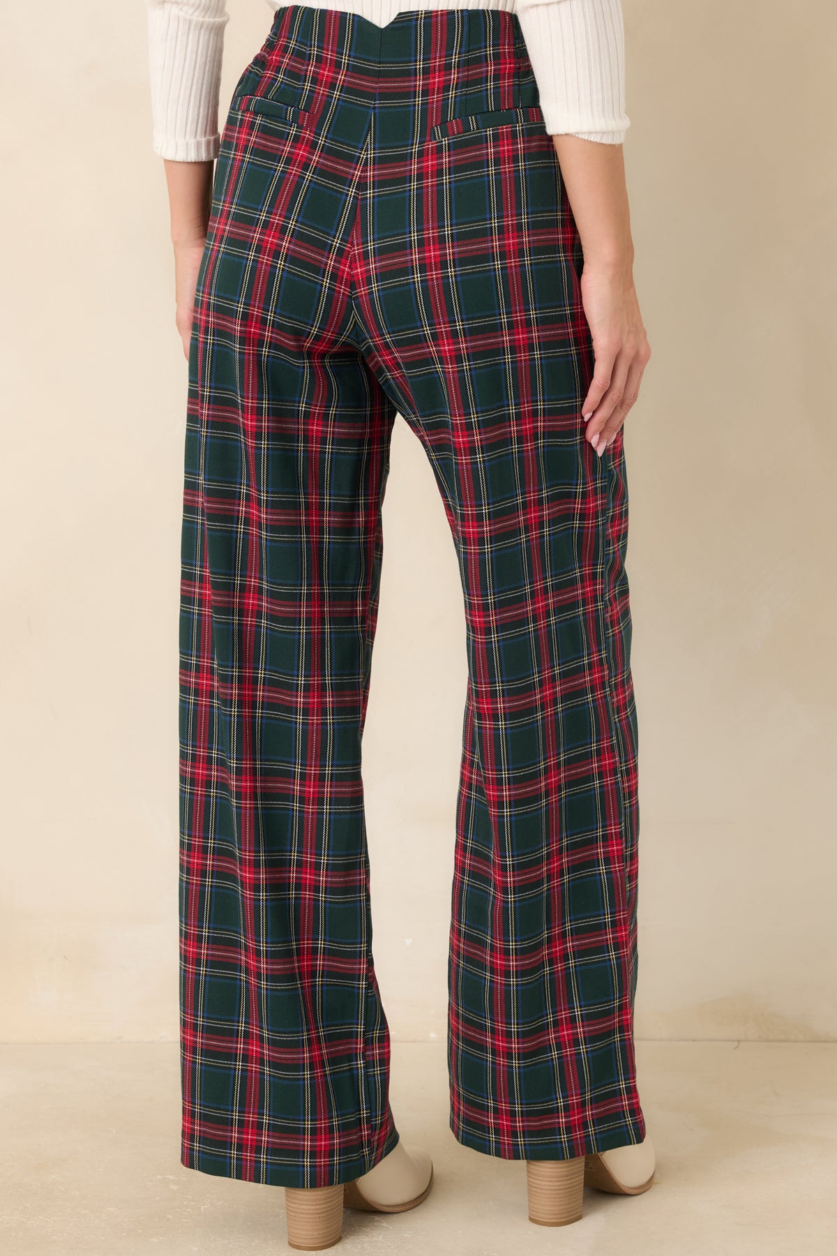 Rear view of the green plaid trousers featuring faux welt back pockets and a wide-leg silhouette.