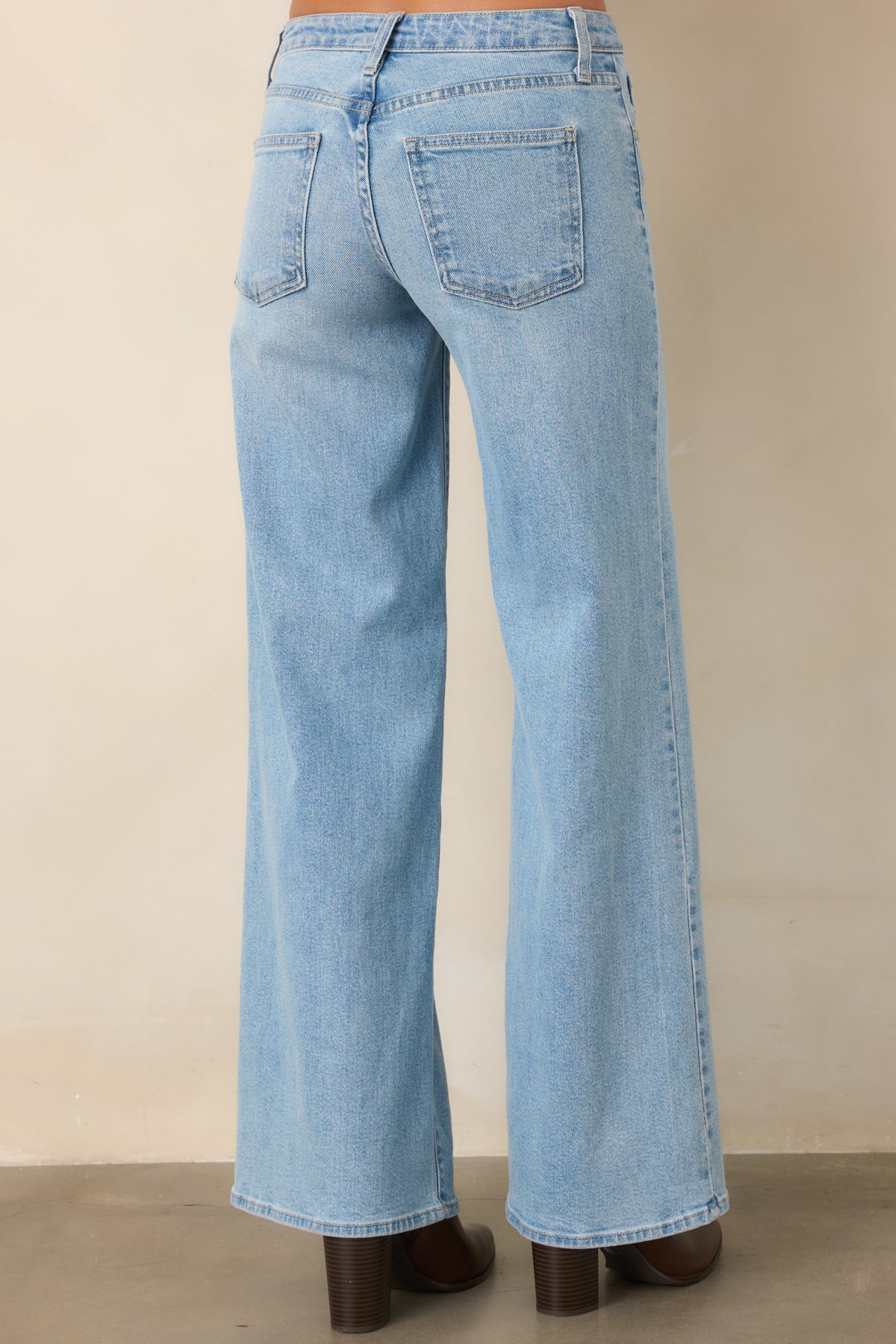The rear of the light wash pants continues the relaxed wide leg silhouette with a comfortable waist fit.