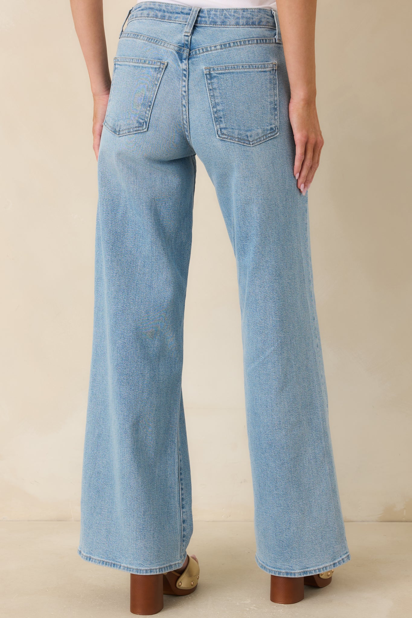 Rear view of the light wash wide leg jeans highlighting the relaxed silhouette and classic denim construction.