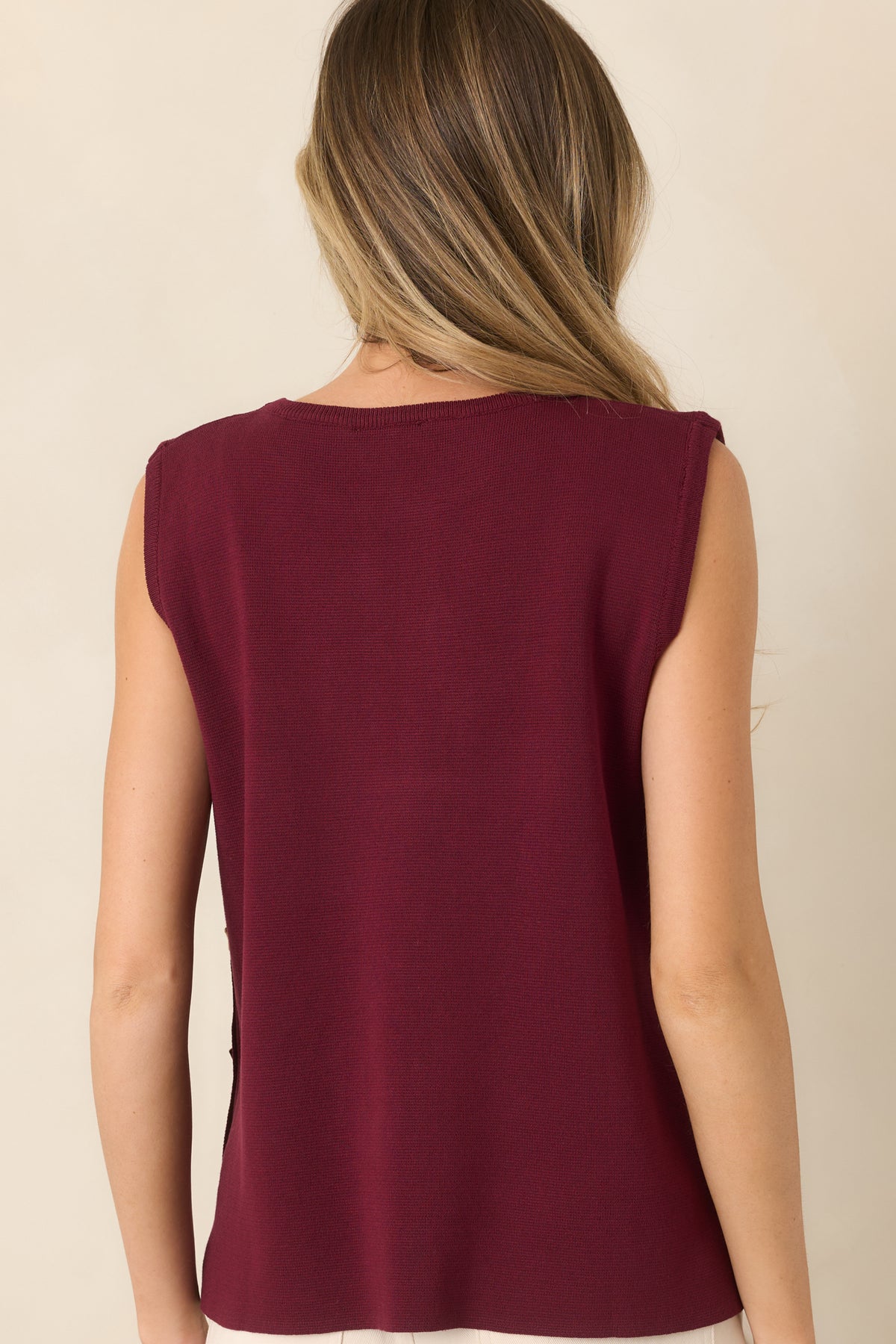Rear view of the lightweight sleeveless knit top showcasing its relaxed drape, clean crew neckline, and smooth sweater-knit construction.