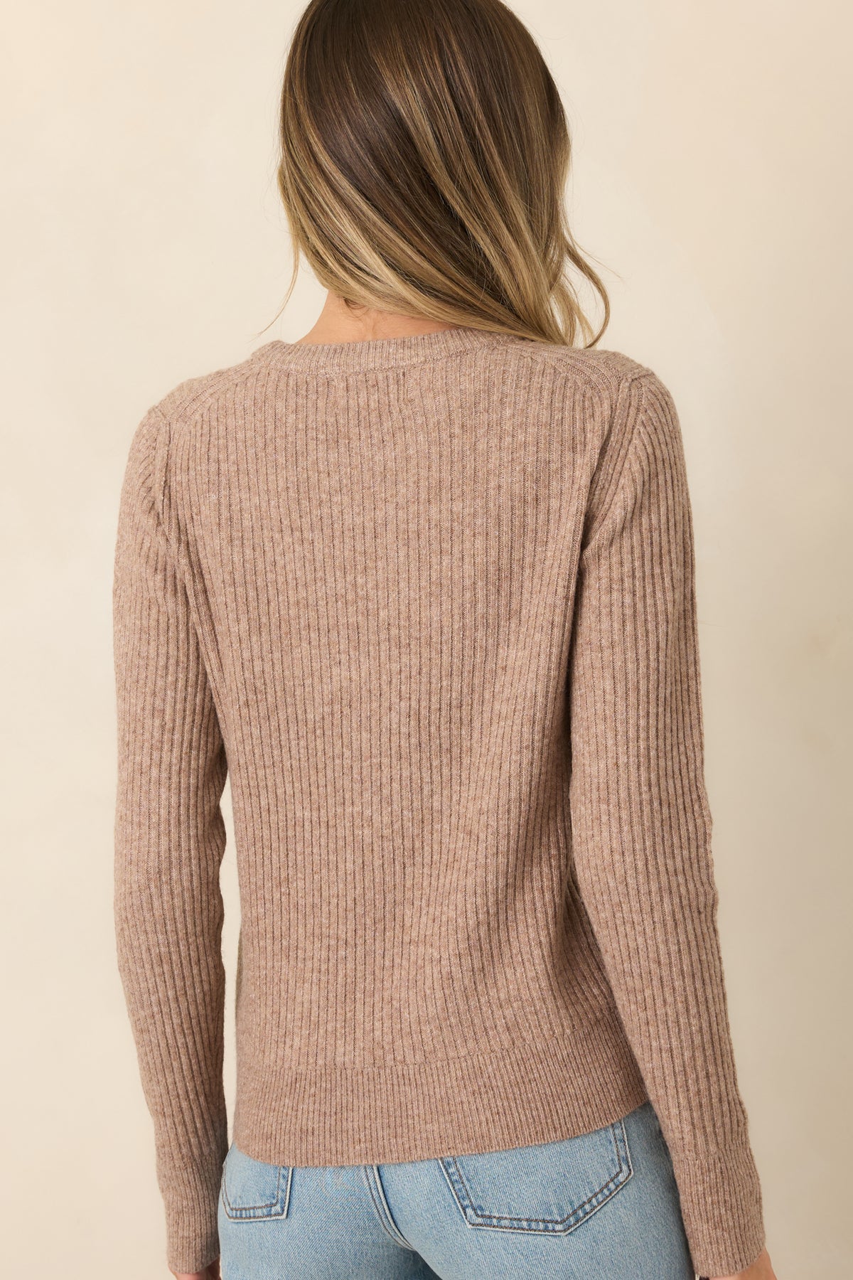 Rear of the mocha ribbed knit top showing its long sleeves and ribbed hem.