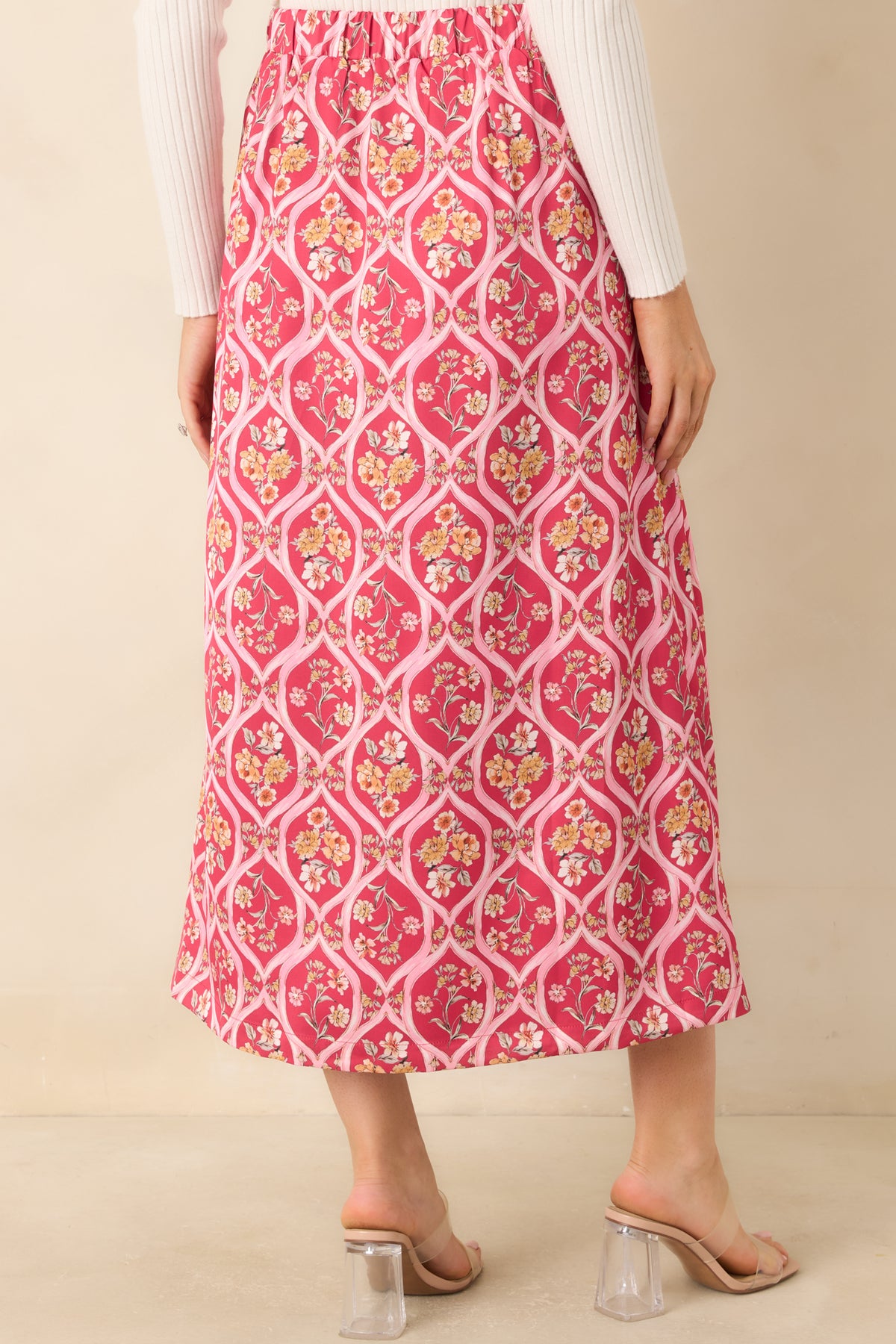 Rear of the pink floral midi skirt featuring an elasticized back waistband and an allover trellis pattern.
